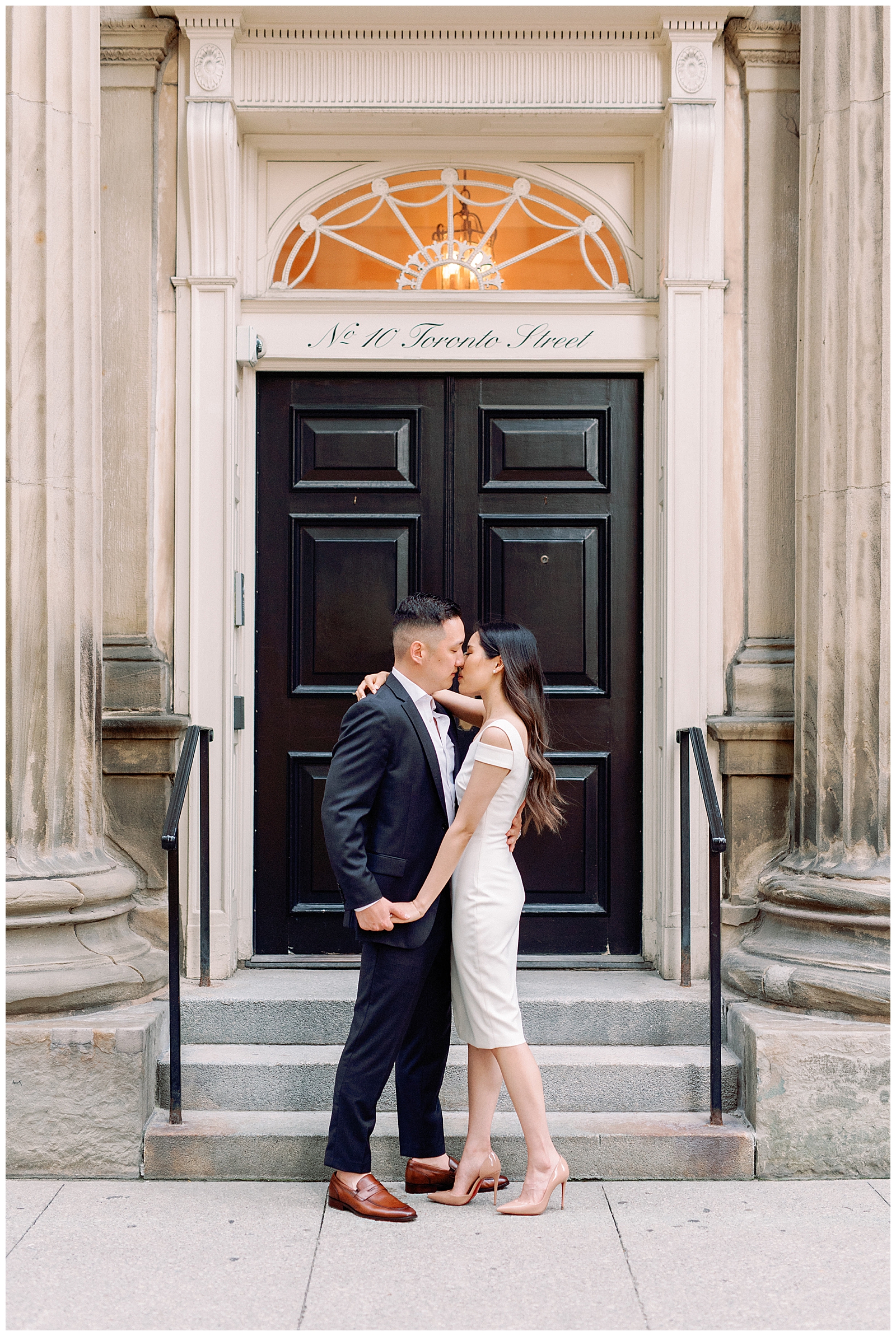 Downtown Toronto Financial District Engagement Session Modern Chic Timeless Couple Embracing in Front of Beautiful Door | Toronto Wedding Photography Jacqueline James Photography