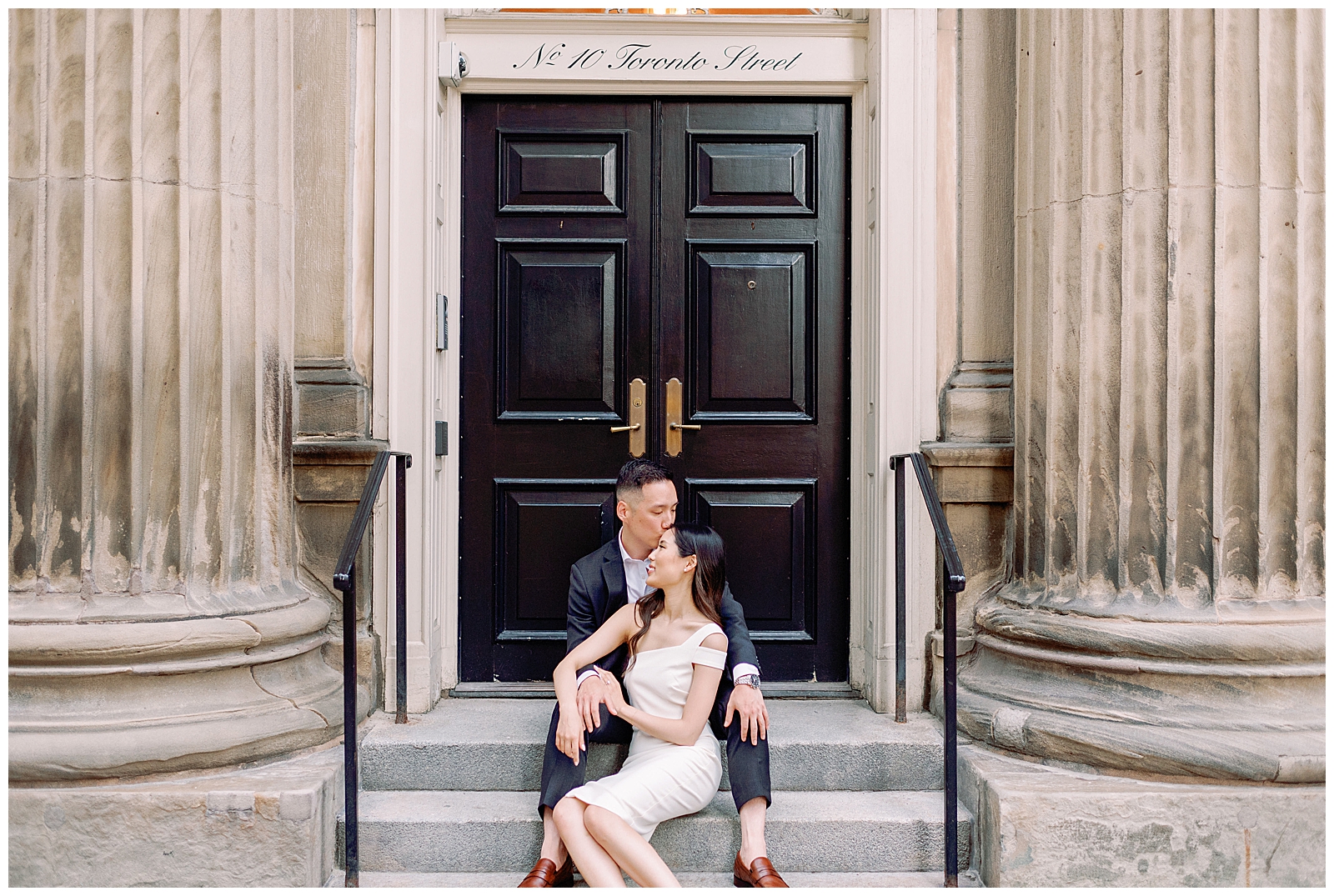 Downtown Toronto Financial District Engagement Session Modern Editorial Timeless Couple Sitting Elegantly in Front of Beautiful Door | Toronto Wedding Photography Jacqueline James Photography