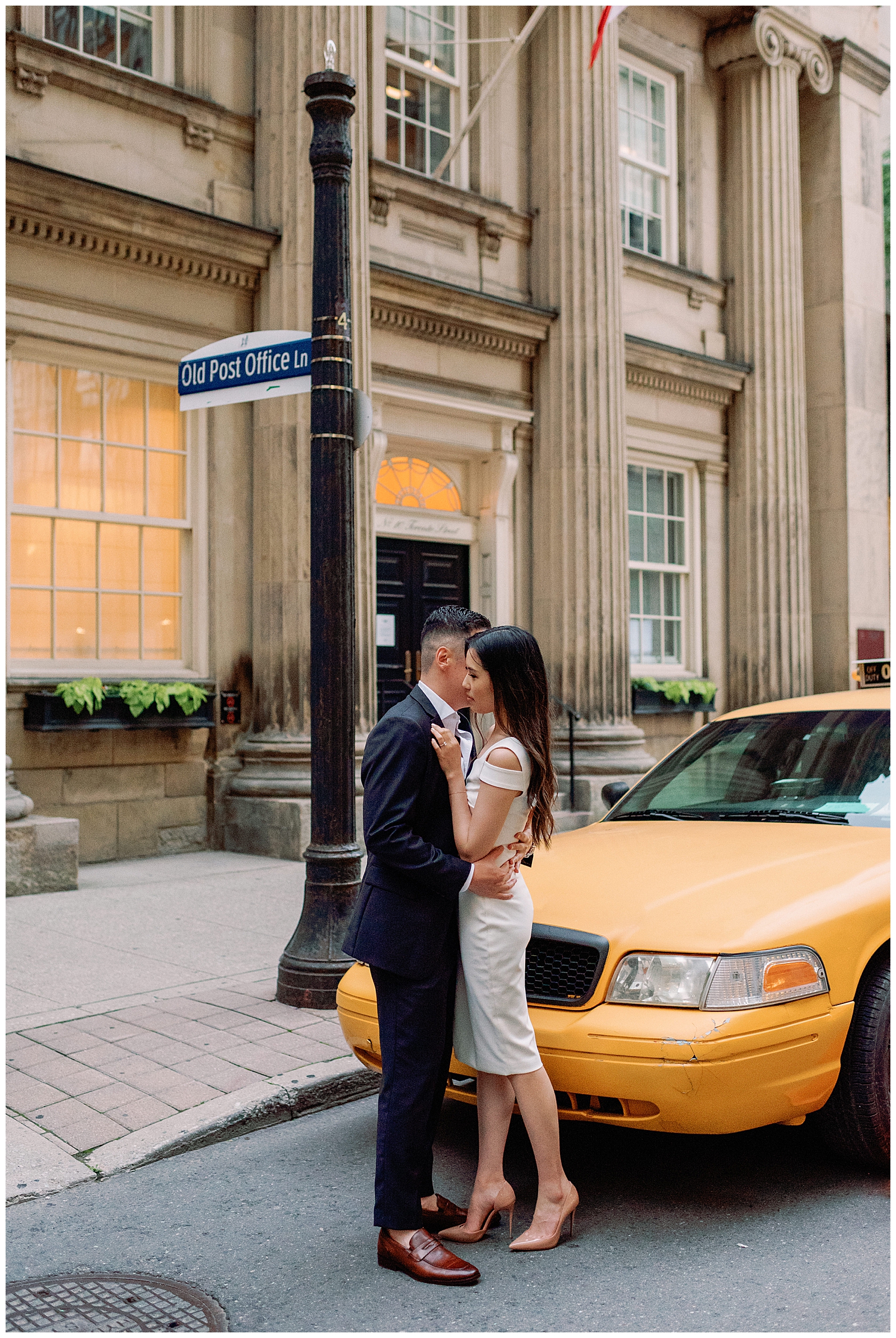 Downtown Toronto Financial District Engagement Session Modern Editorial Timeless Couple Sweet Embrace Yellow taxicab under the moonlight | Toronto Wedding Photography Jacqueline James Photography