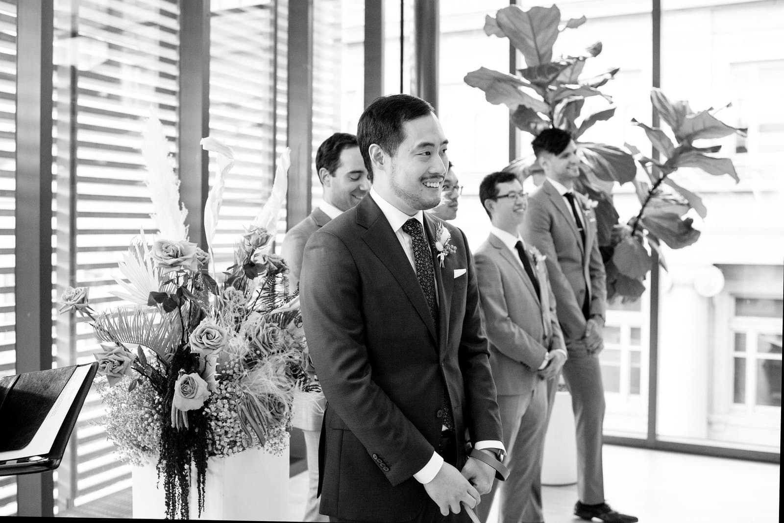 Groom first emotional happy look at Bride walking up the aisle at Ceremony at gardiner museum downtown toronto modern romantic wedding jacqueline james photography