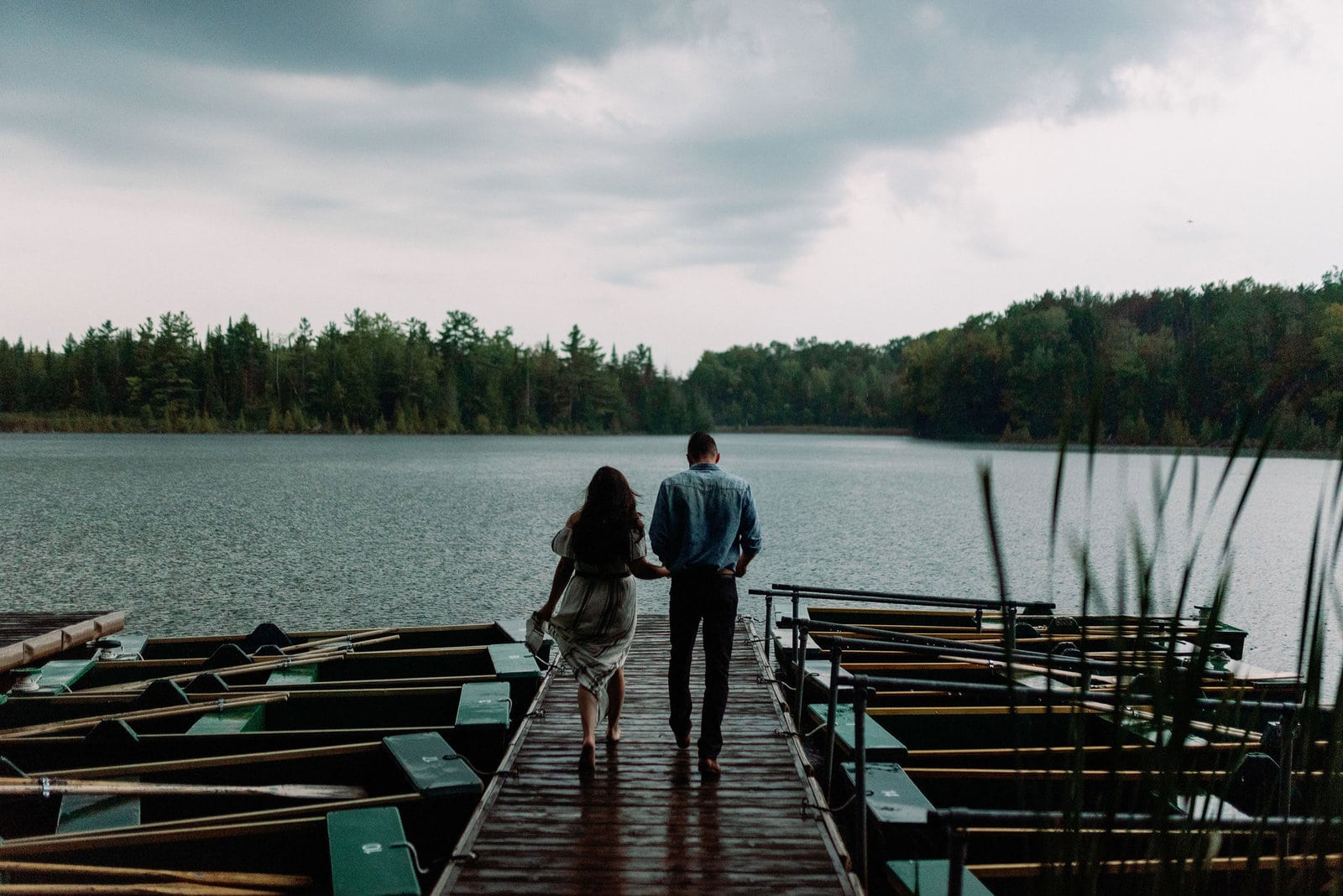 couple romantic embrace stormy engagement photos toronto jacqueline james photography rowboats the notebook storm clouds