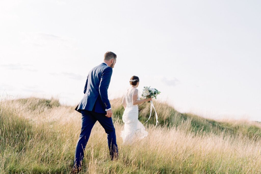 Adventurous couple climb hill at pipers heath wedding toronto wedding venue jacqueline james photography