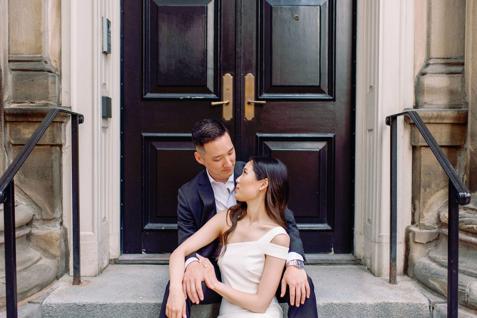 Downtown Toronto Engagement Photos Financial District Modern Editorial Timeless Couple Sitting Elegantly in Front of Beautiful Door | Toronto Wedding Photography Jacqueline James Photography