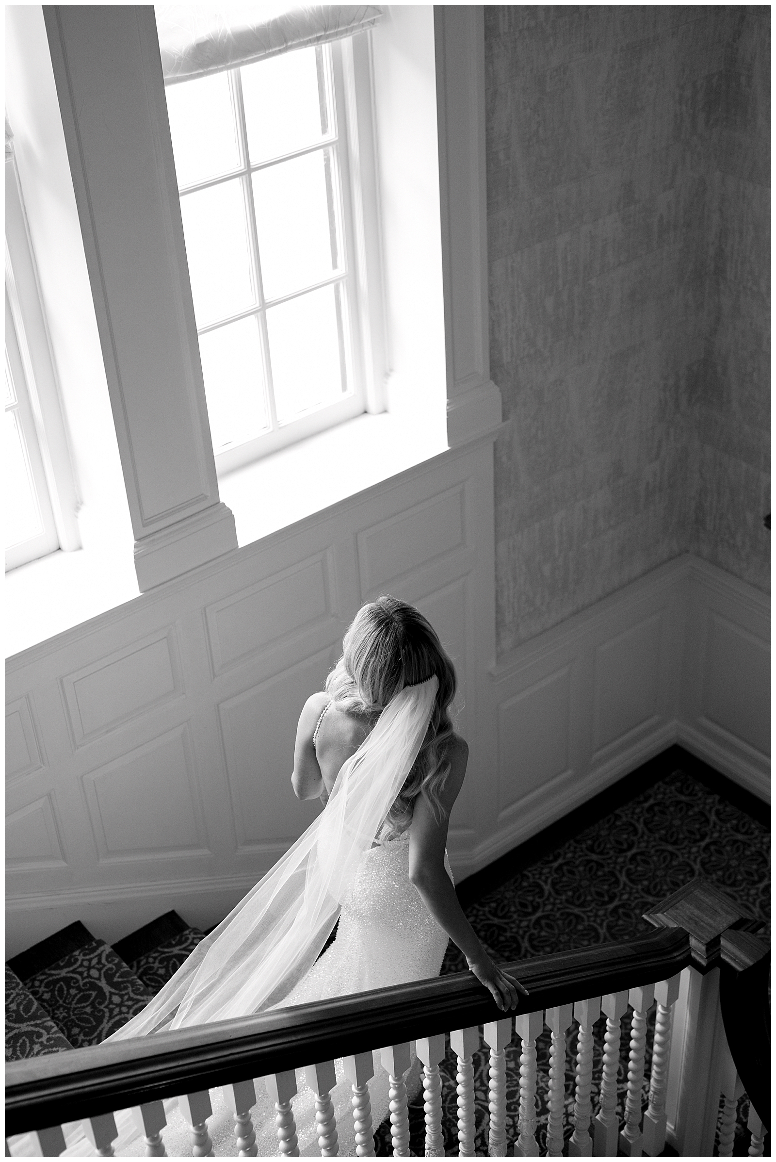 Editorial portrait of bride walking down the stairs elegantly at Graydon Hall Manor Toronto Wedding