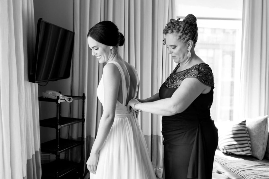 emotional mother helps bride into wedding dress at Gladstone Hotel Wedding Toronto Wedding Venue Jacqueline James Photography