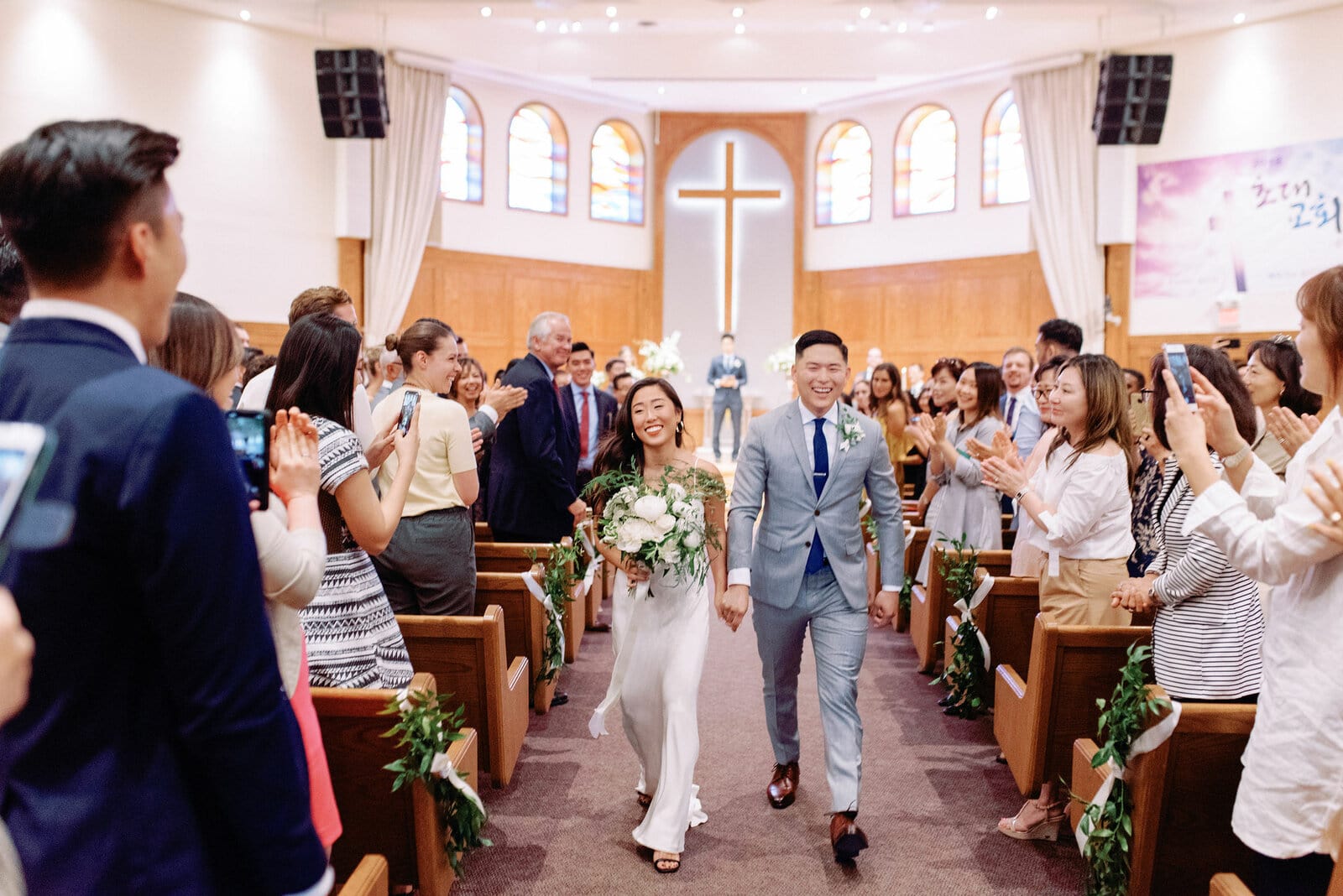 Modern Bride and Groom Happy Joyful Recessional in church korean ceremony Toronto Wedding Photographer Jacqueline James Photography