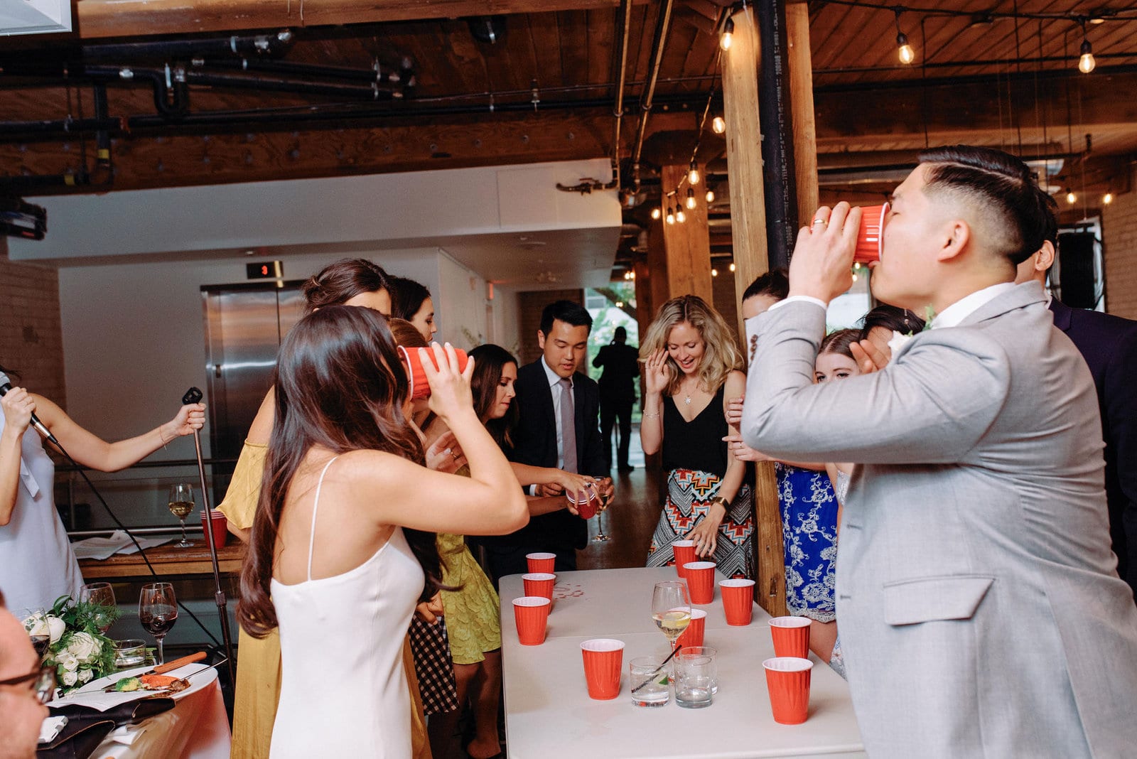 Bride and Groom Flip Cup Spontaneous Fun Game During Reception at Hotel Ocho Downtown Toronto Wedding Photographer Jacqueline James Photography