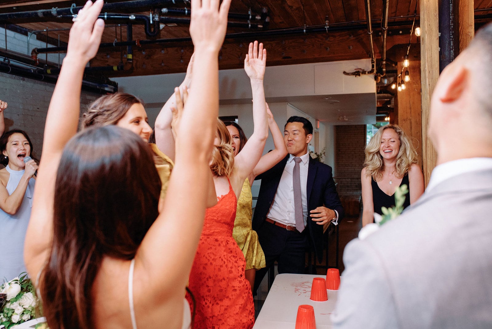 Bride and Groom Flip Cup Spontaneous Fun Game During Reception at Hotel Ocho Downtown Toronto Wedding Photographer Jacqueline James Photography