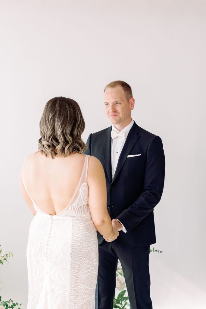 Groom Looks at Bride Lovingly at Intimate Wedding Ceremony Lovt Studio Downtown Toronto Wedding Venue Jacqueline James Photography