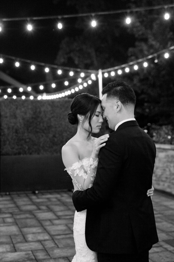 Editorial Bride and Groom dance under twinkle lights at Guild Inn Estate Wedding Hailey Bieber Wedding Dress Toronto Wedding Venue Jacqueline James Photography