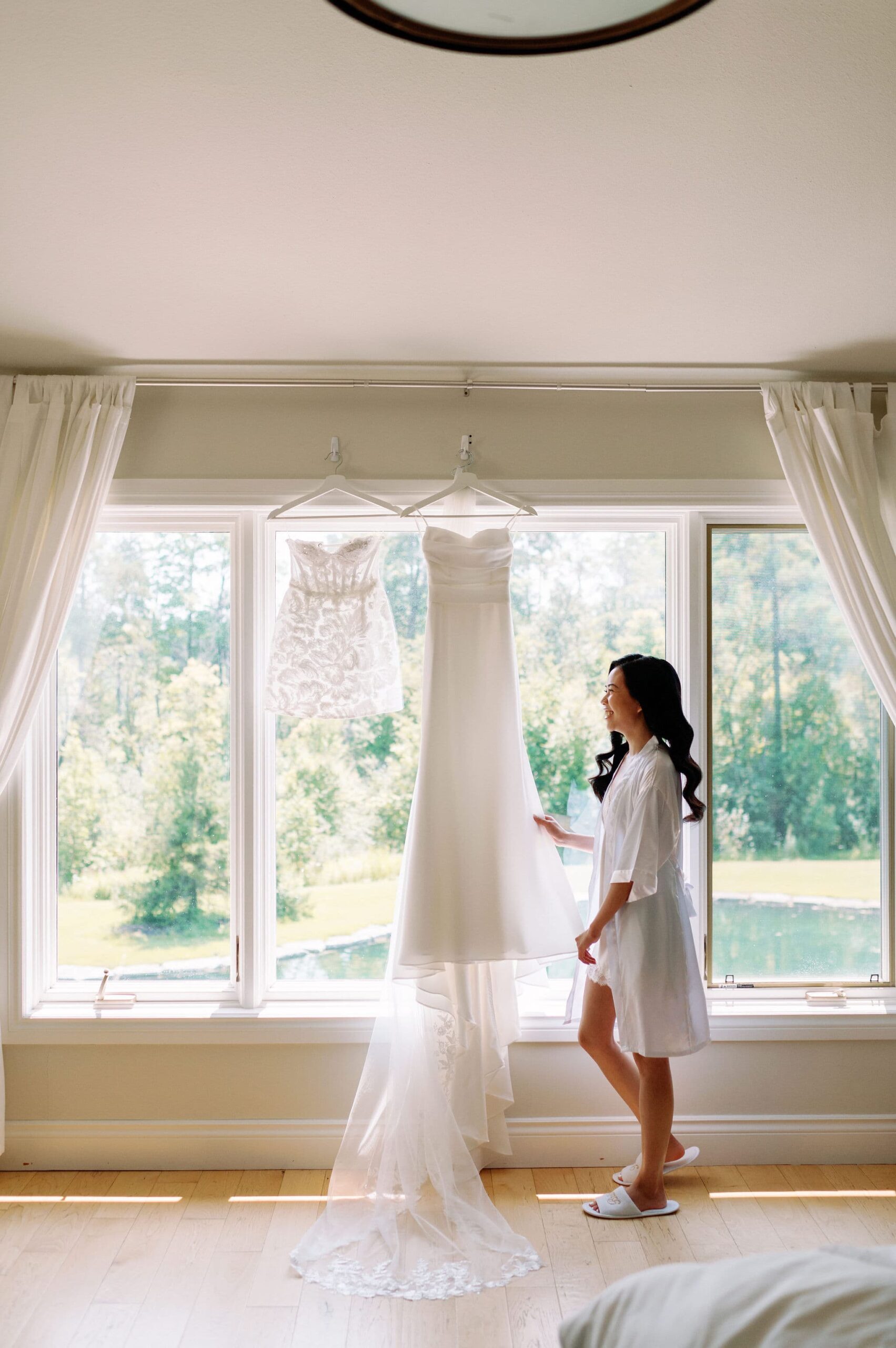 bride getting ready looking at wedding dress morning happy smiles laughter whistle bear golf club wedding