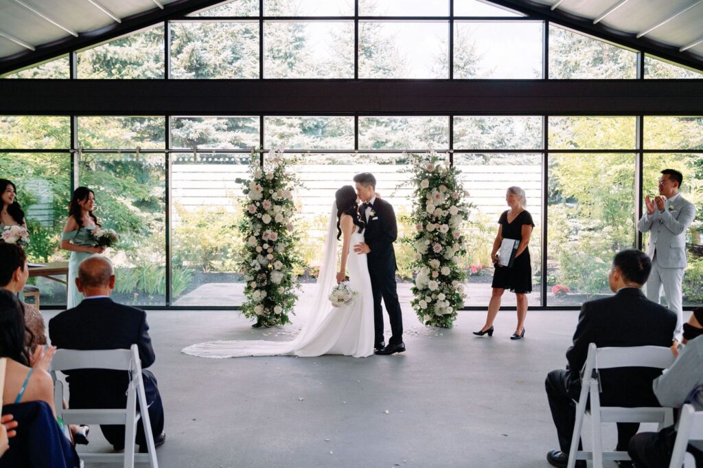 couples first kiss at ceremony at whistle bear golf club wedding cambridge