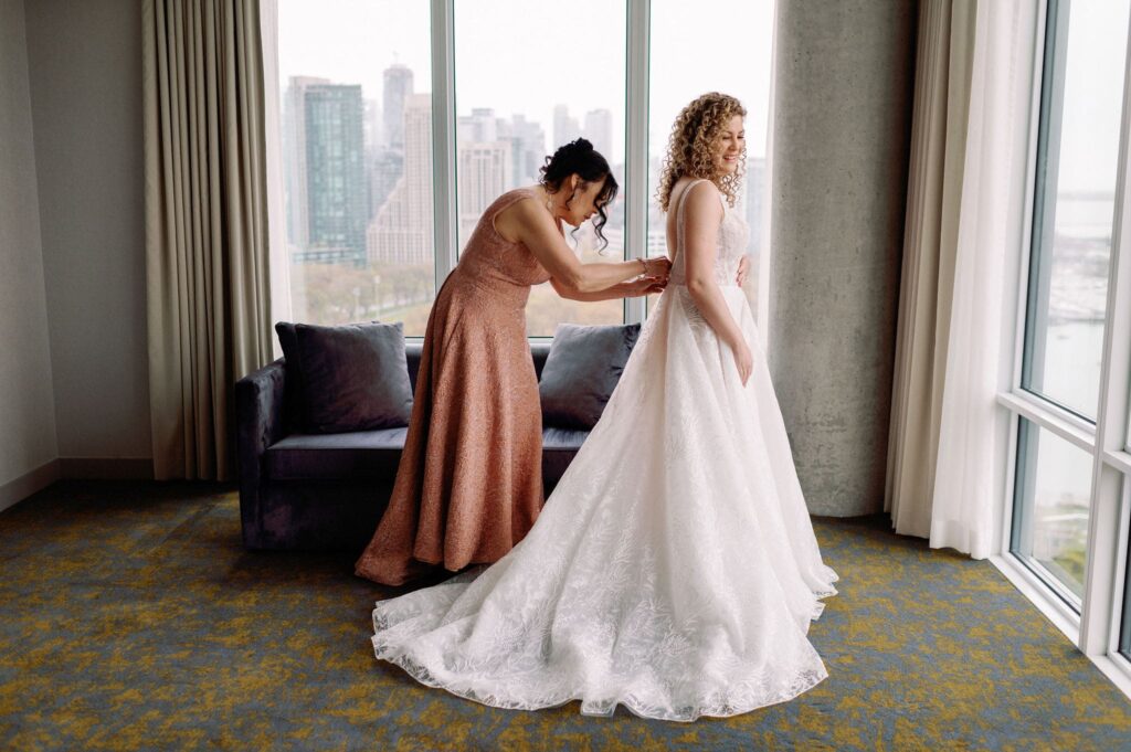 bride getting into wedding dress with mom at hotel x toronto 