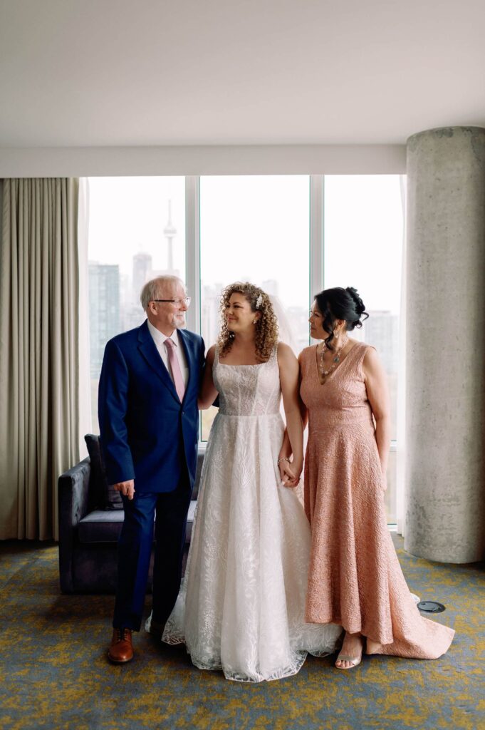 candid moment bride with her parents laughing emotional at hotel x toronto wedding