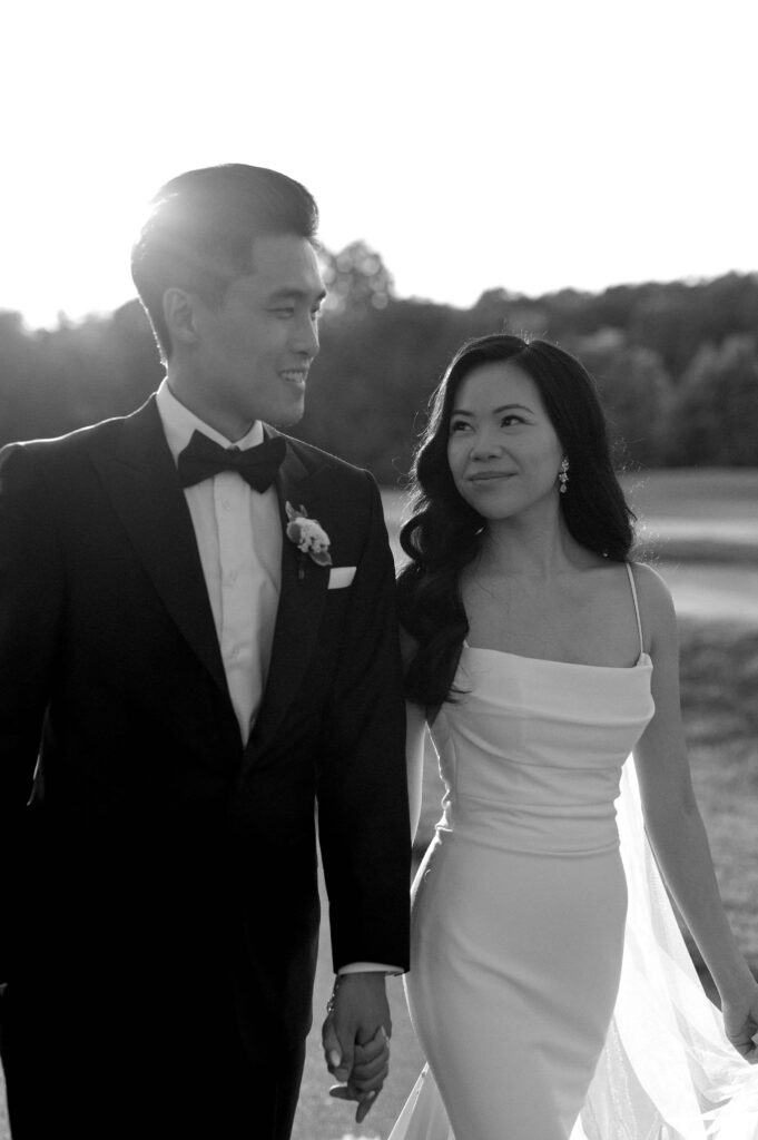 modern editorial timeless wedding portrait at sunset golden hour bride and groom walking at whistle bear golf club wedding cambridge