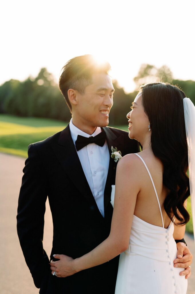 modern editorial timeless wedding portrait at sunset golden hour bride and groom walking at whistle bear golf club wedding cambridge