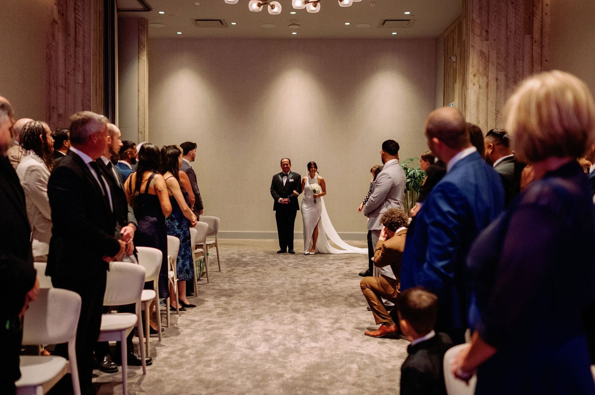 Bride walking up the aisle with her father at 1 Hotel Toronto wedding ceremony