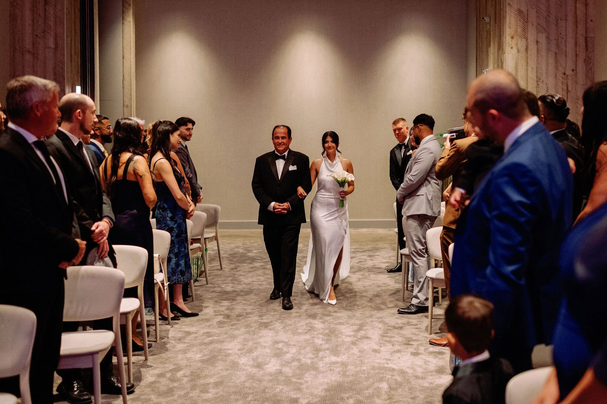 Bride walking up the aisle with her father at 1 Hotel Toronto wedding ceremony