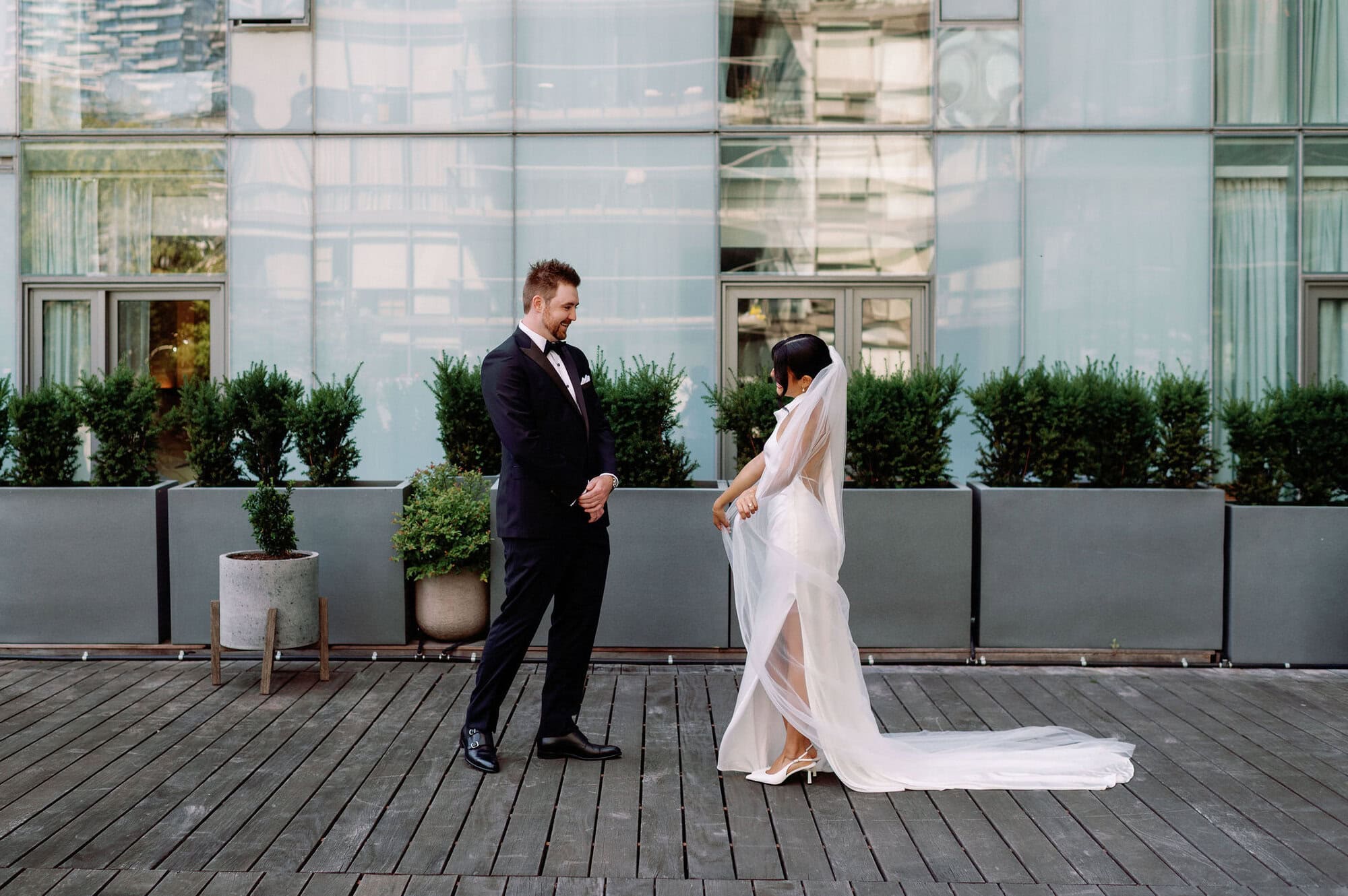 Groom turning to see bride during first look at 1 Hotel Toronto