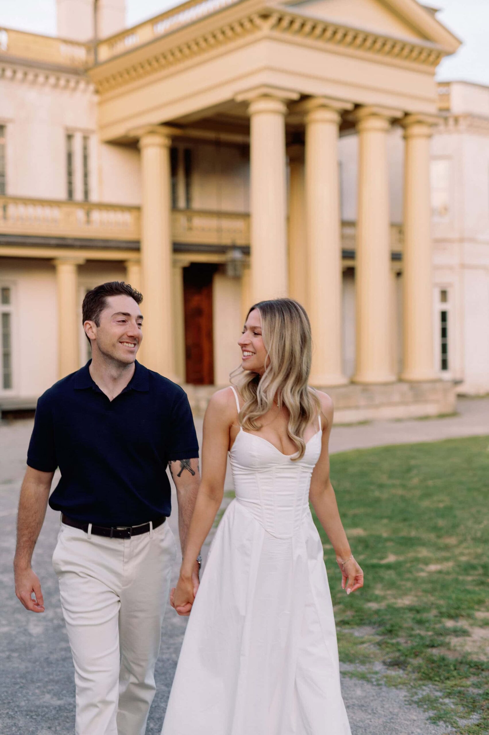 Joyful walk at golden hour with Dundurn Castle Hamilton behind them