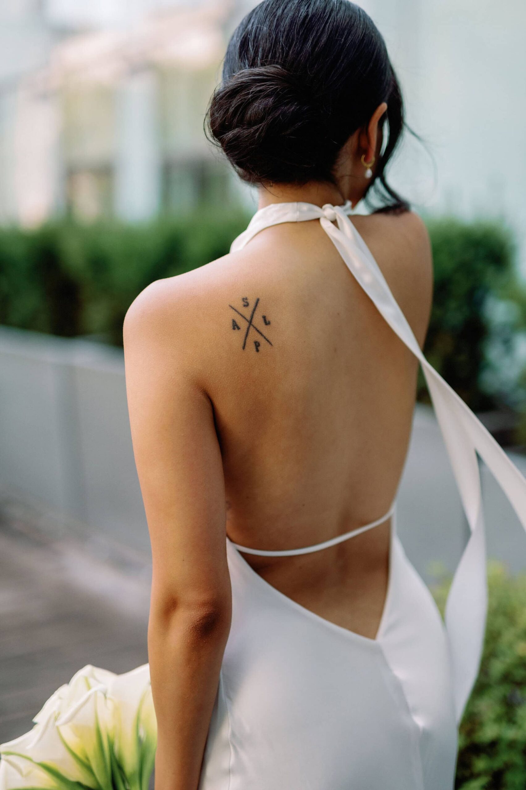 Bride’s open back gown and tattoo captured during portraits at 1 Hotel Toronto.