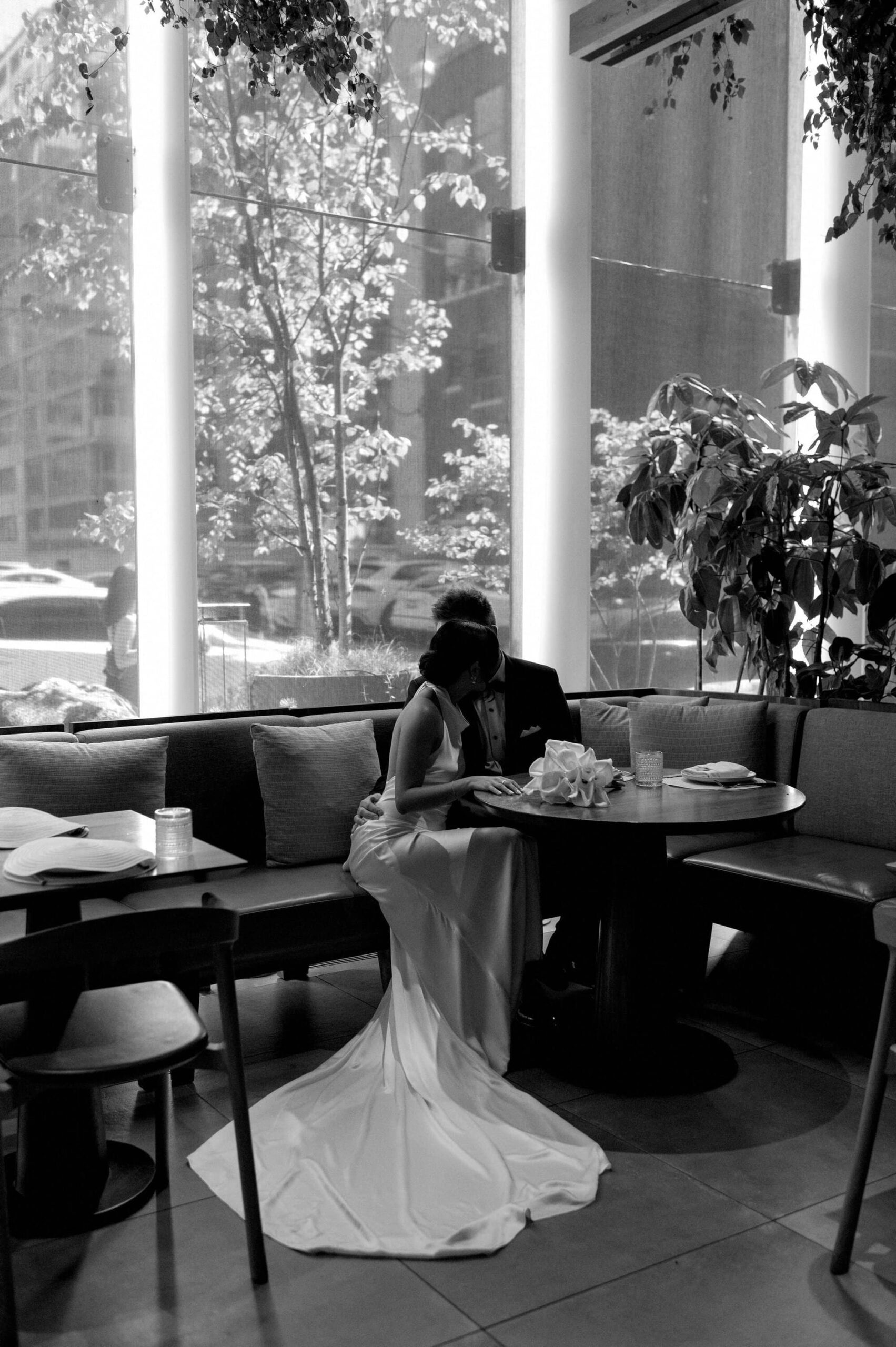 Black and white candid of the couple sitting together at 1 Hotel Toronto.