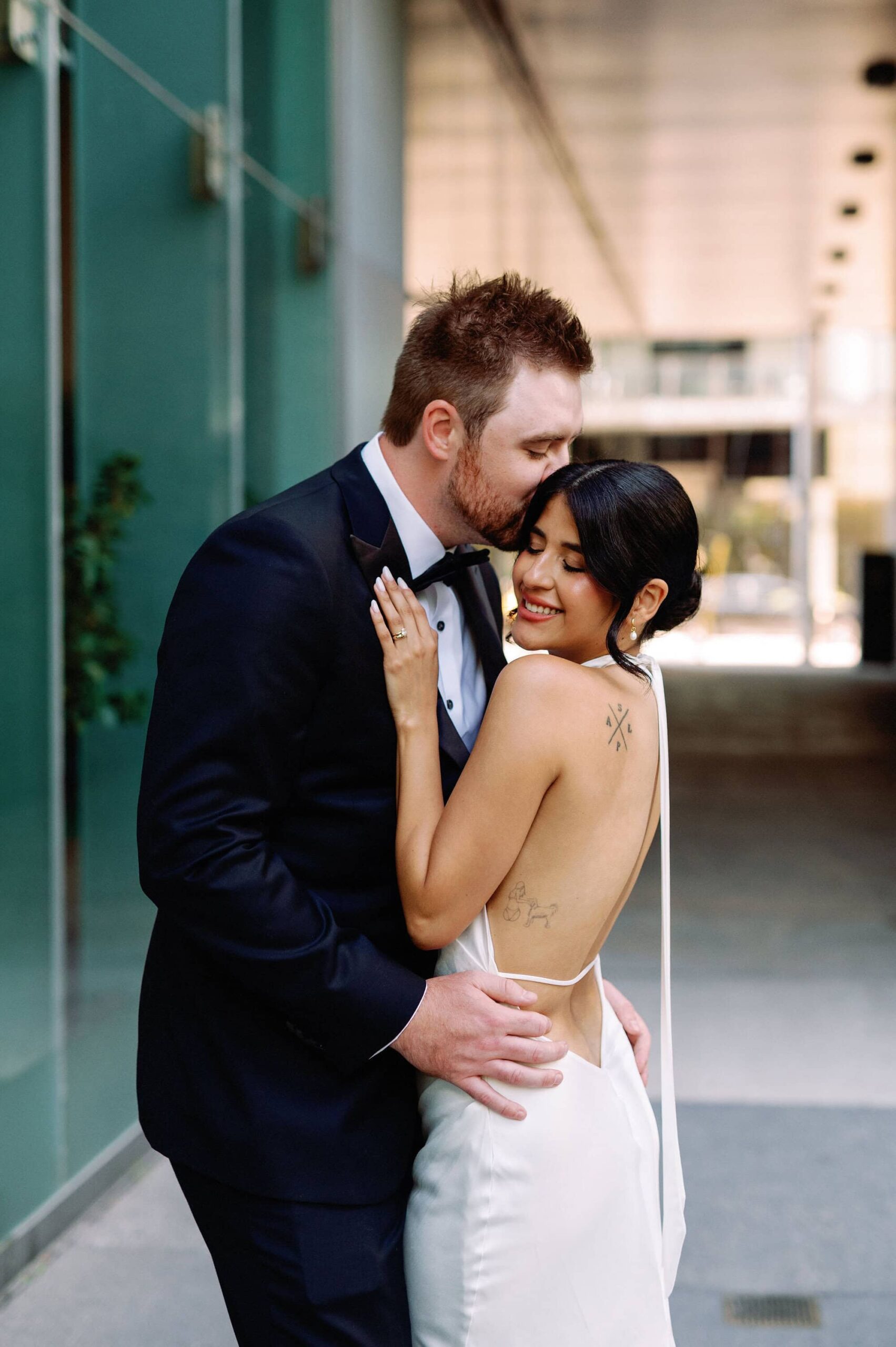 Groom holding the bride close during outdoor wedding portraits at 1 Hotel Toronto.