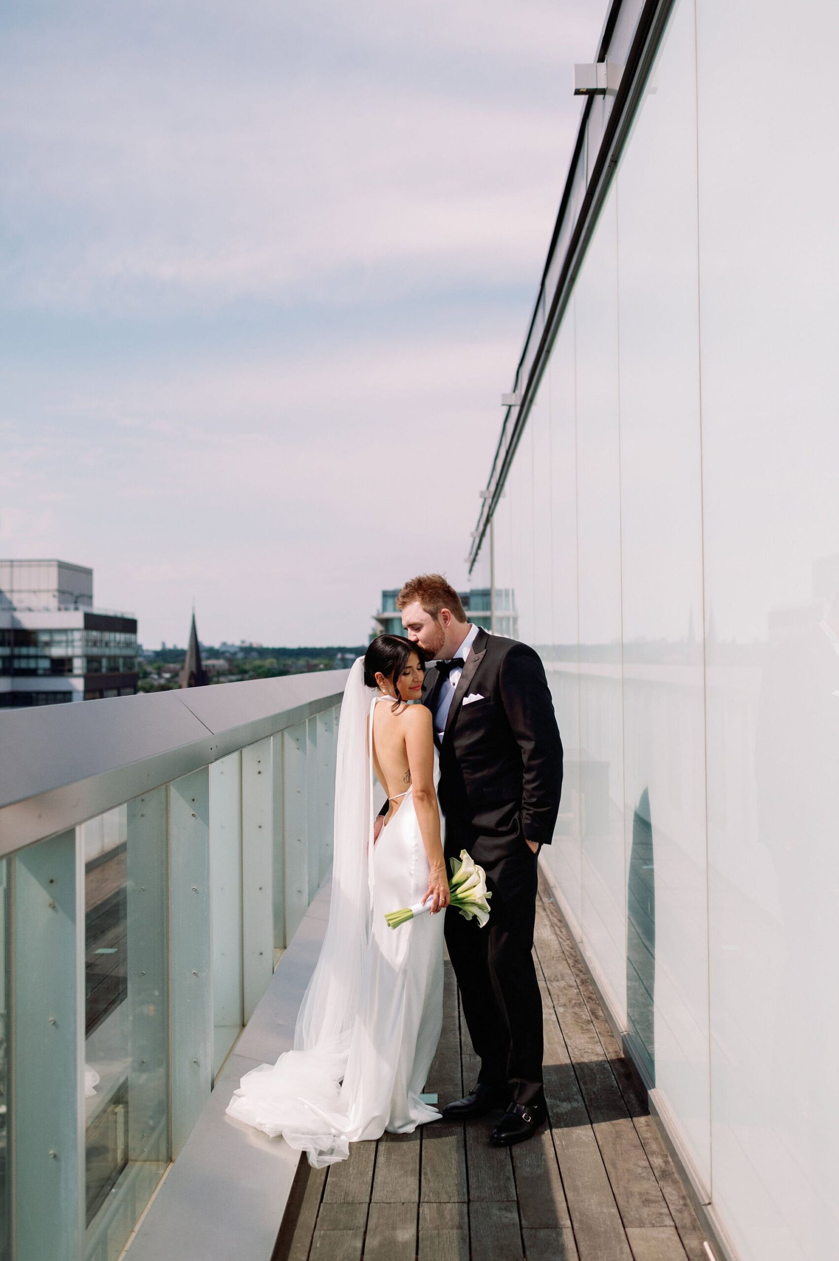 Romantic moment between the couple overlooking the Toronto skyline at 1 Hotel Toronto.