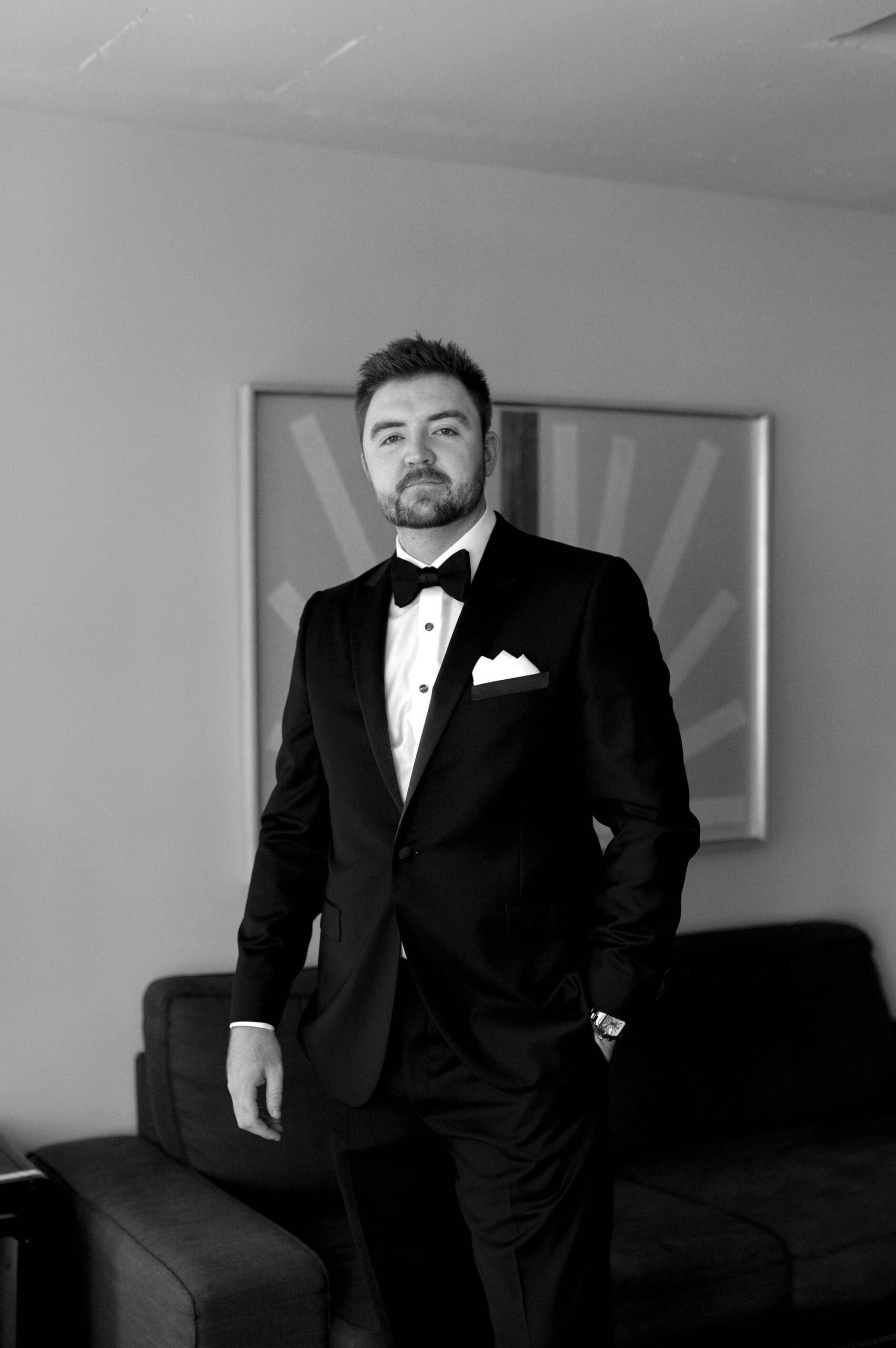 Groom standing for a classic portrait inside 1 Hotel Toronto before the wedding ceremony.
