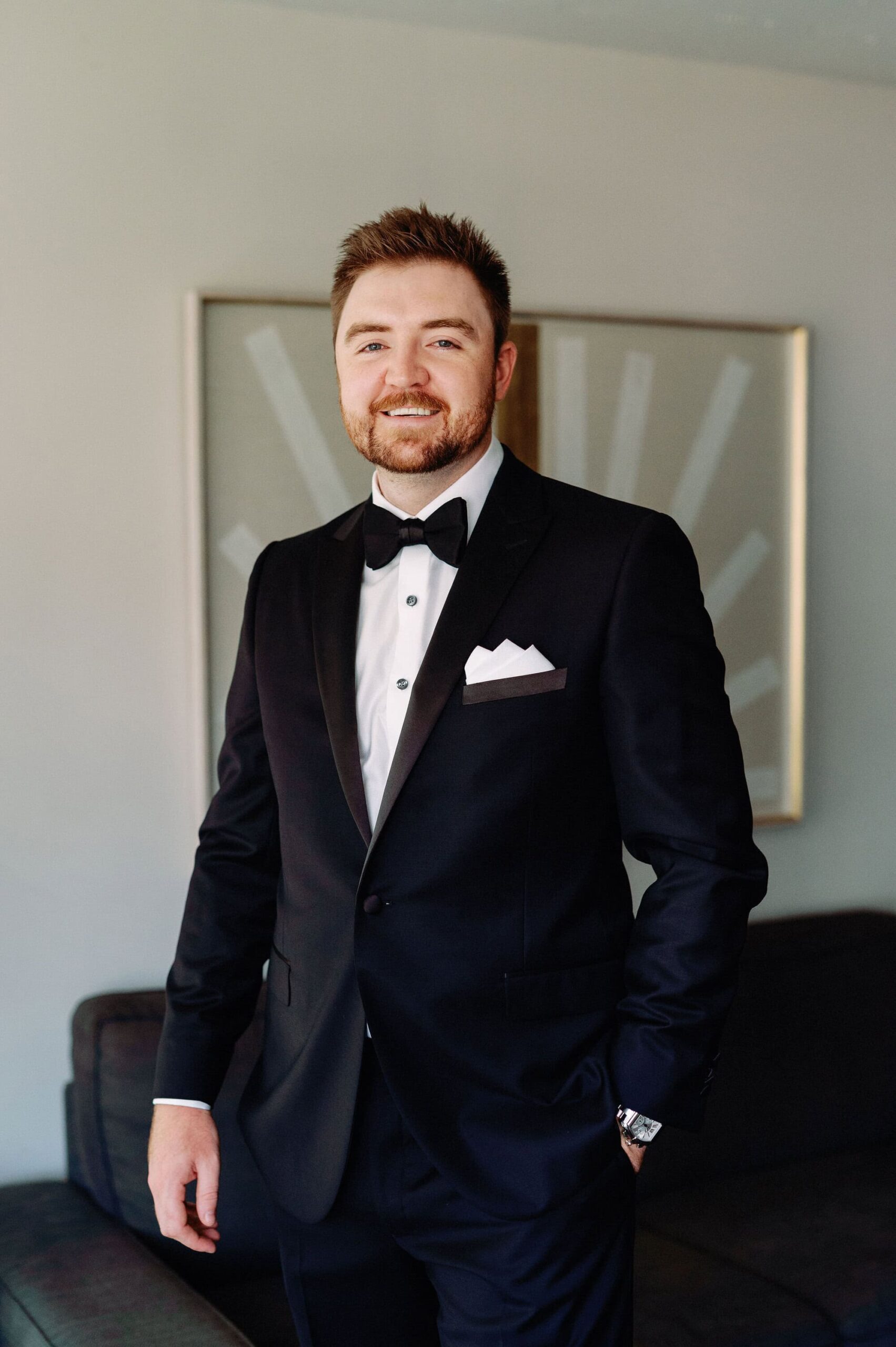 Groom standing for a classic portrait inside 1 Hotel Toronto before the wedding ceremony.