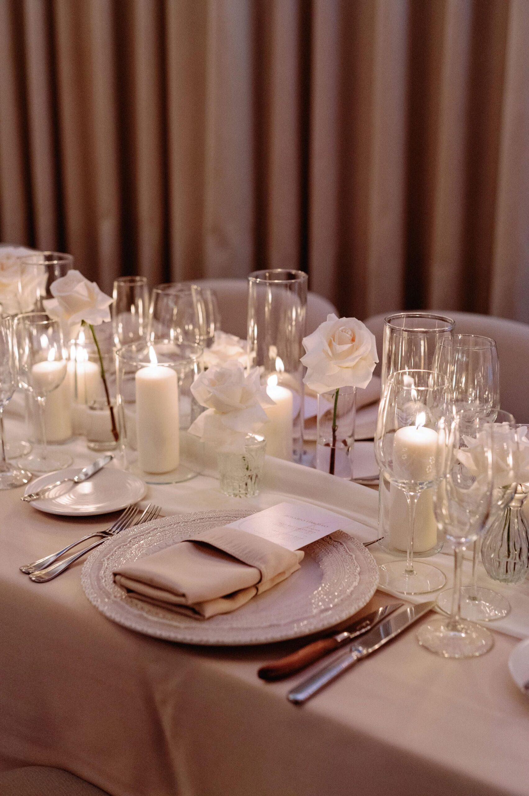 Detailed view of white florals and candlelit table décor at a 1 Hotel Toronto wedding.