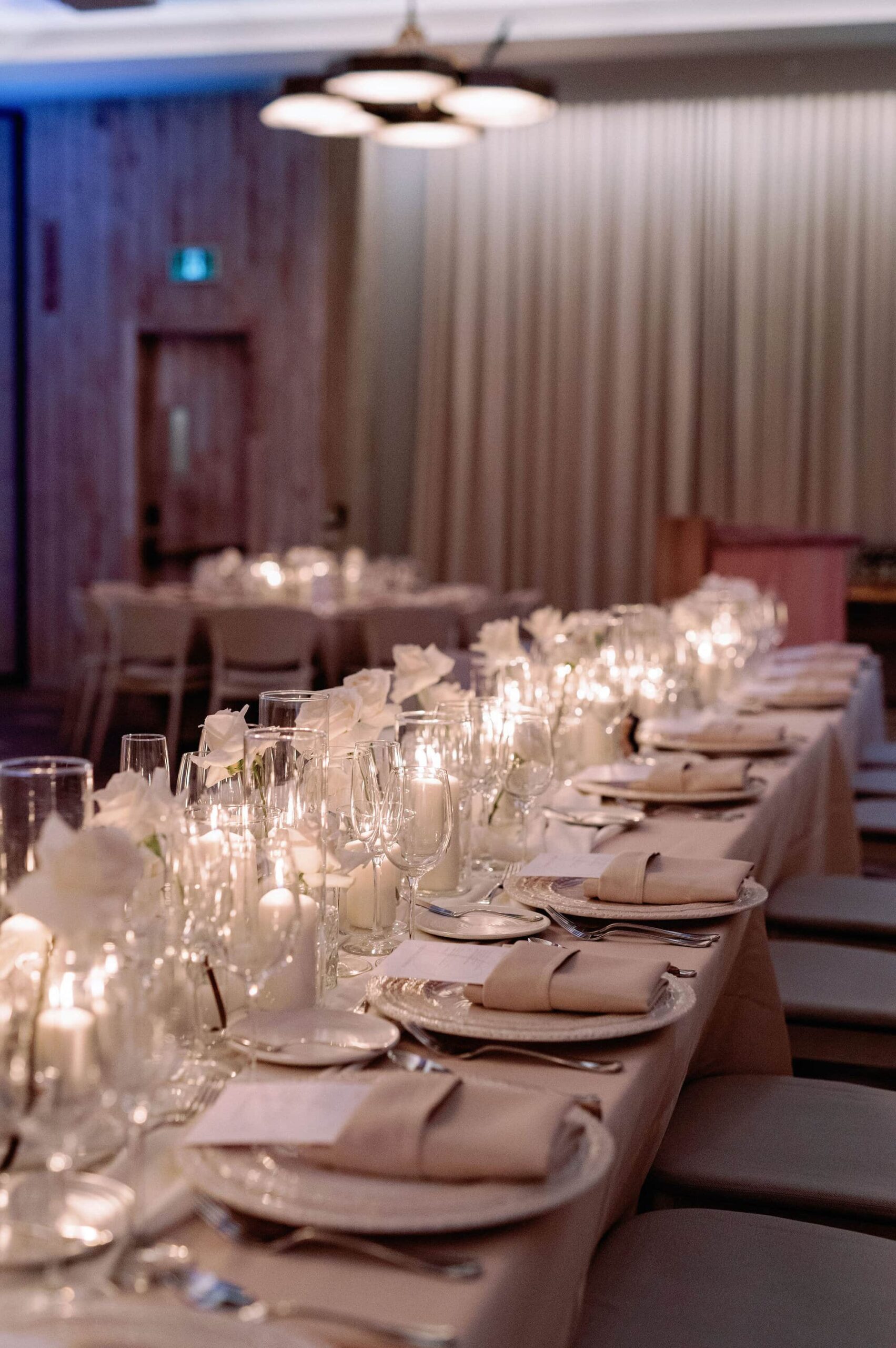 Detailed view of white florals and candlelit table décor at a 1 Hotel Toronto wedding.
