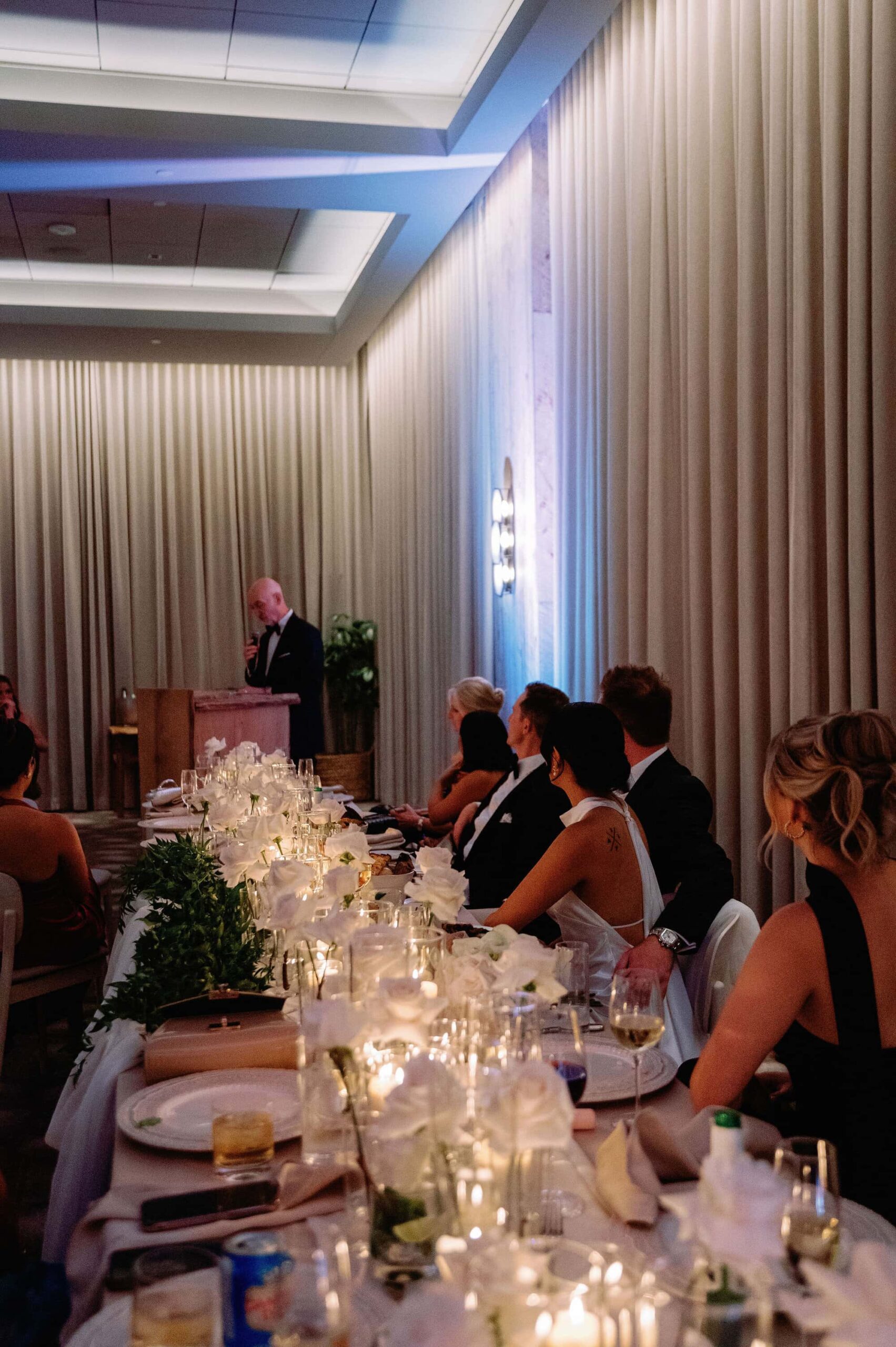 Guests watching speeches at a long candlelit dinner table at 1 Hotel Toronto.