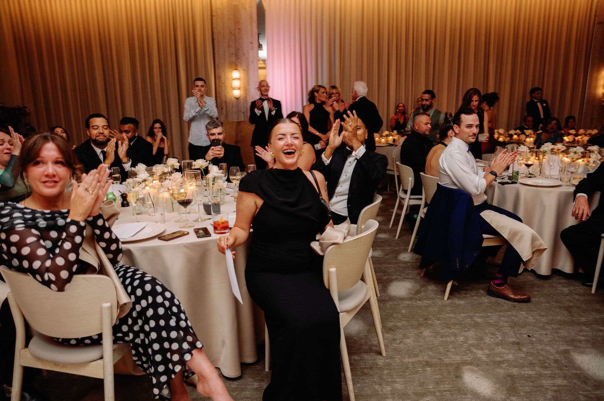 Guests watching speeches at a long candlelit dinner table at 1 Hotel Toronto.