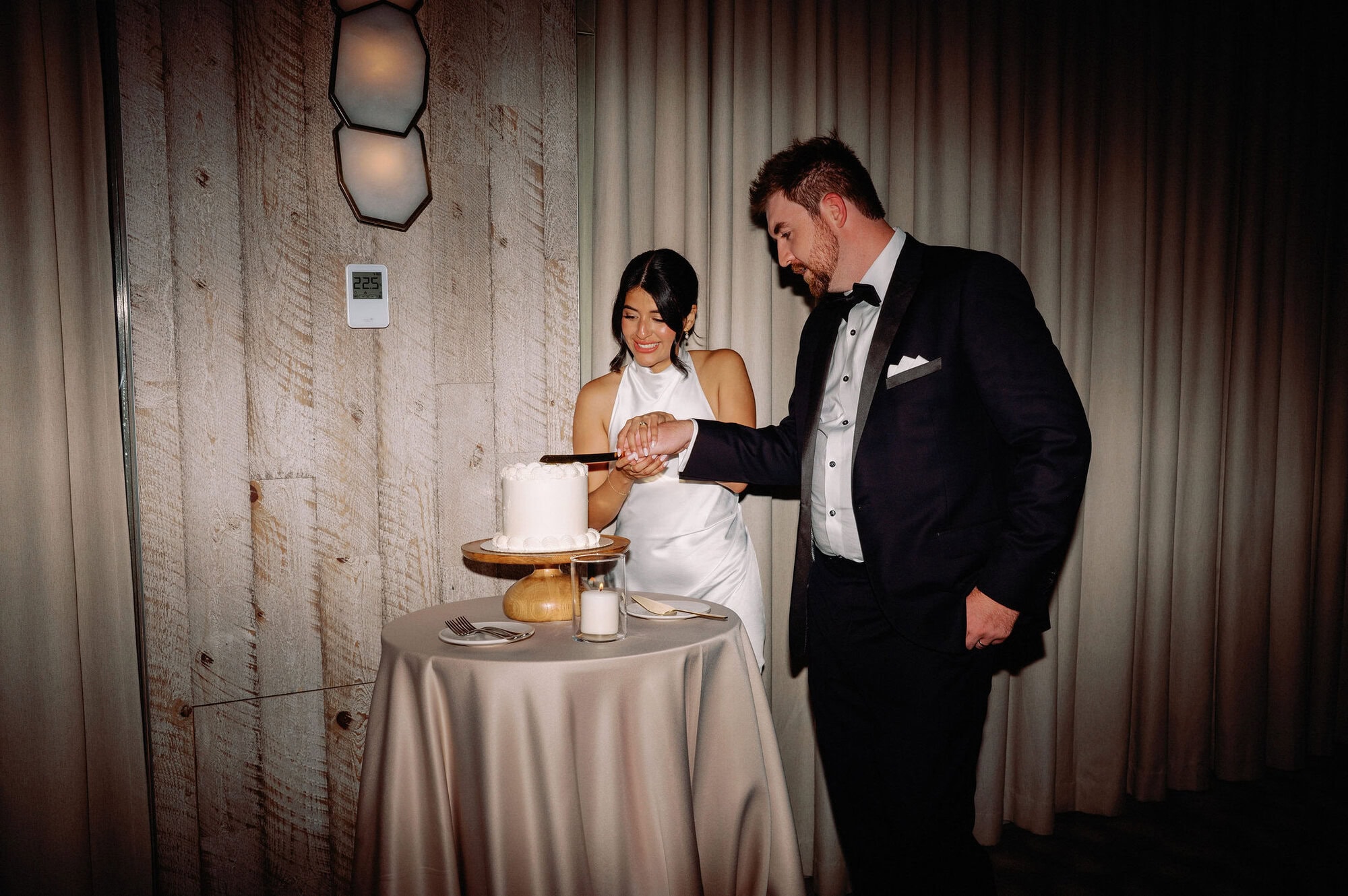 Fun moment of the bride and groom feeding each other cake during their 1 Hotel Toronto wedding