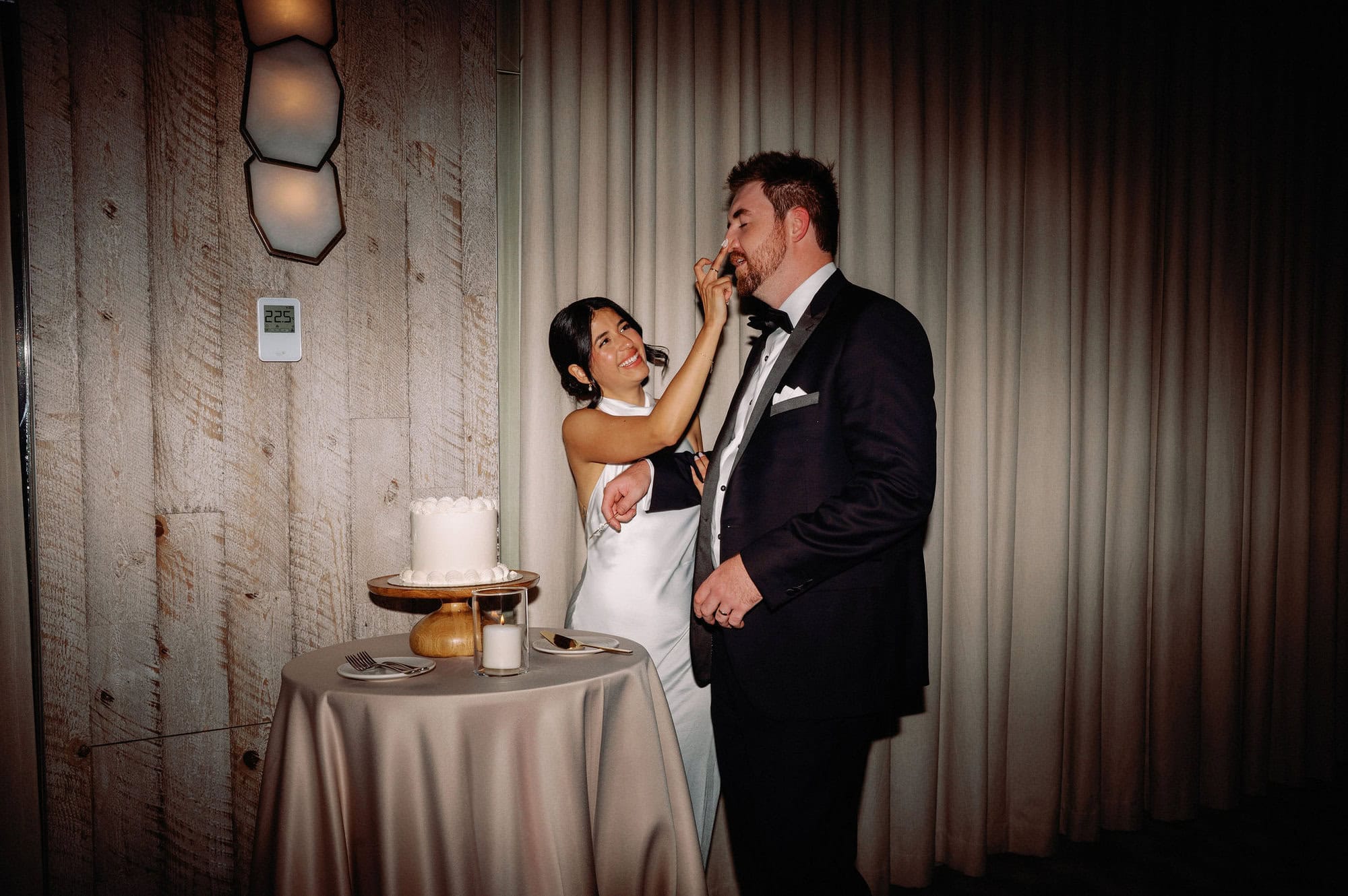 Bride and groom cutting their wedding cake at 1 Hotel Toronto during their reception.