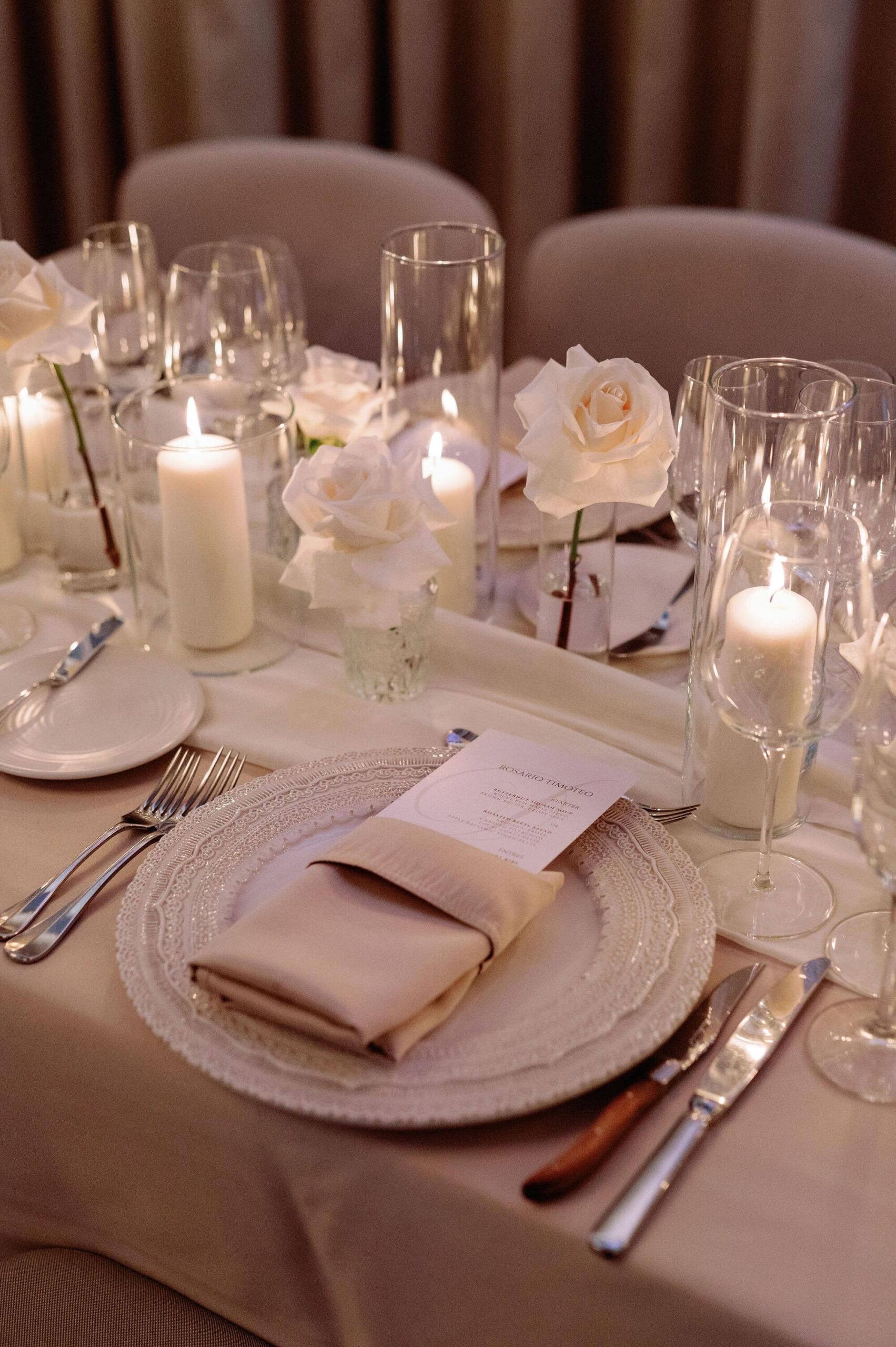 Detailed view of white florals and candlelit table décor at a 1 Hotel Toronto wedding.