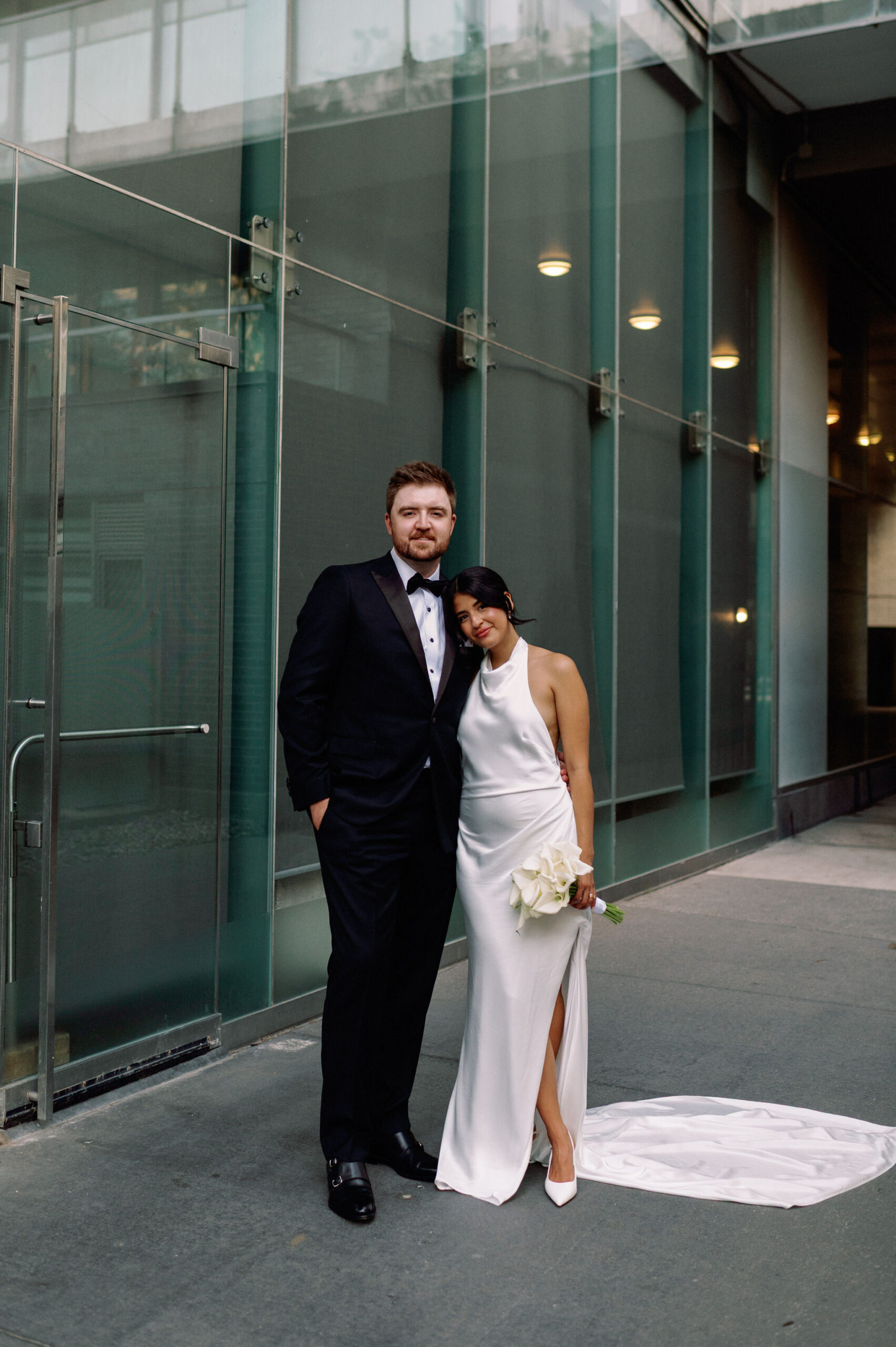 Bride and groom posing together outside 1 Hotel Toronto in a modern city portrait.