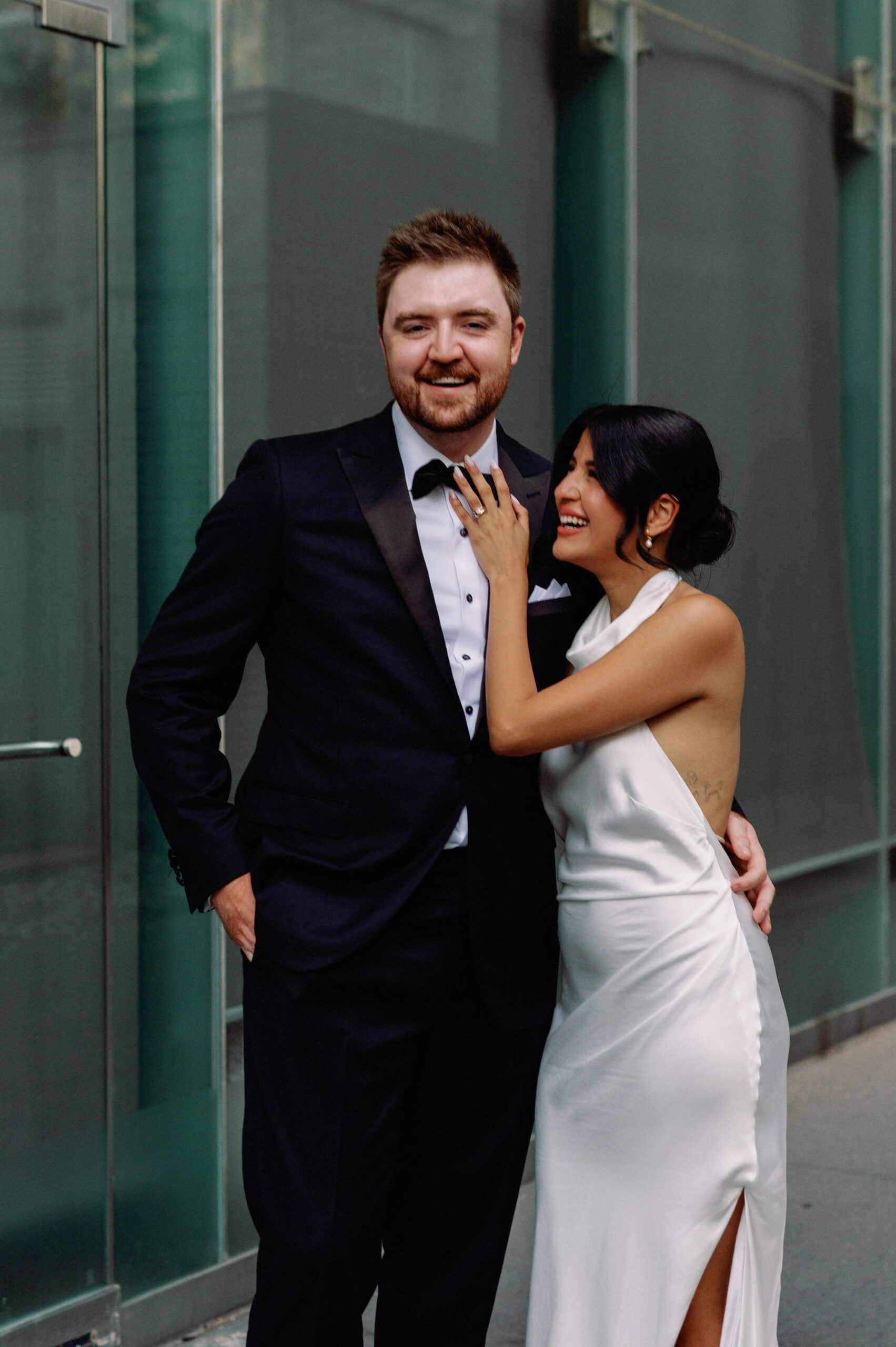 Bride and groom posing together outside 1 Hotel Toronto in a modern city portrait.
