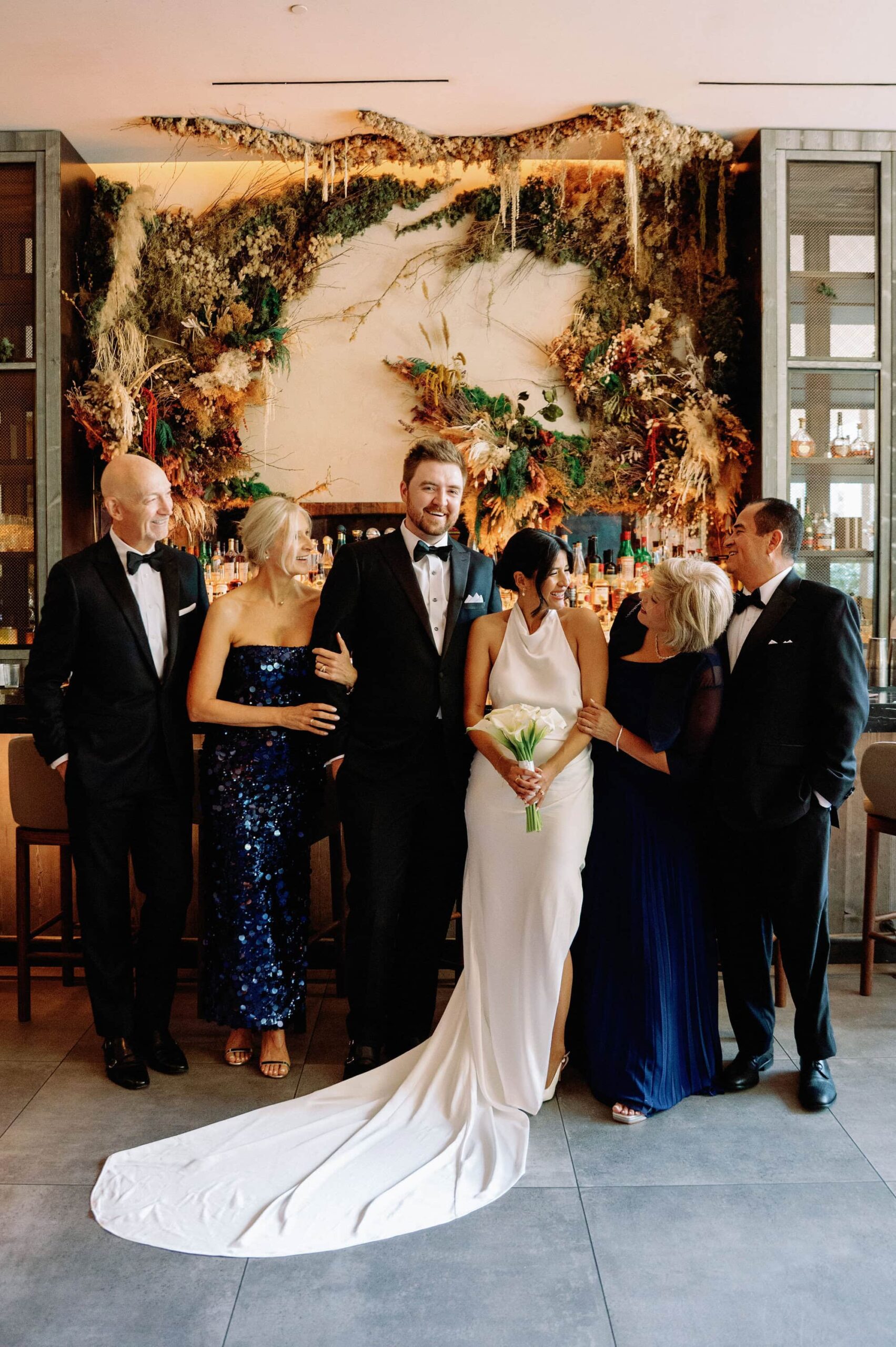 Family wedding portrait taken at 1 Hotel Toronto in front of the floral bar installation.
