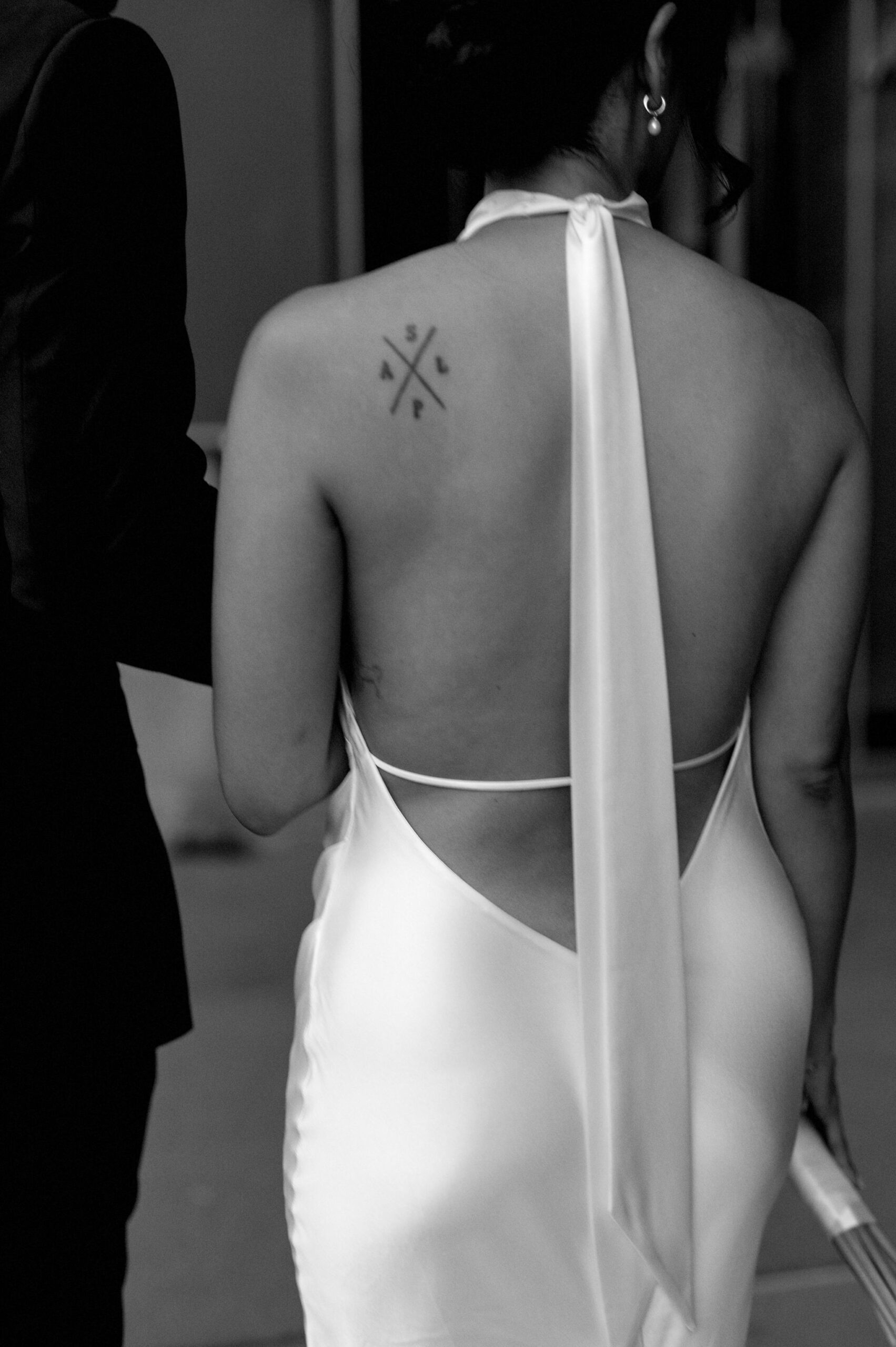 Bride’s open back satin gown photographed at 1 Hotel Toronto during wedding portraits.