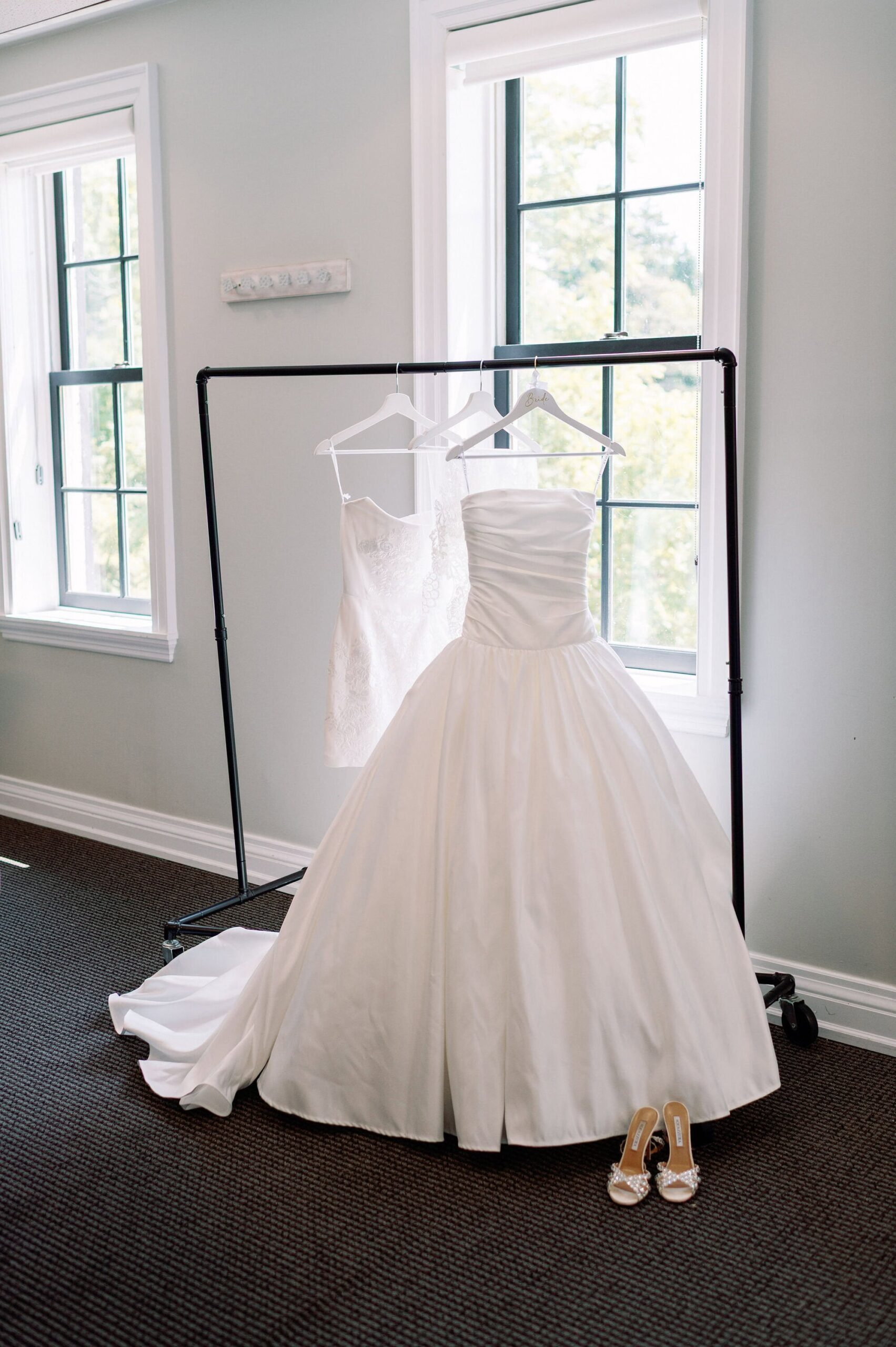 Bride’s wedding gown hanging in the bridal suite at Harding Waterfront Estate before the ceremony.