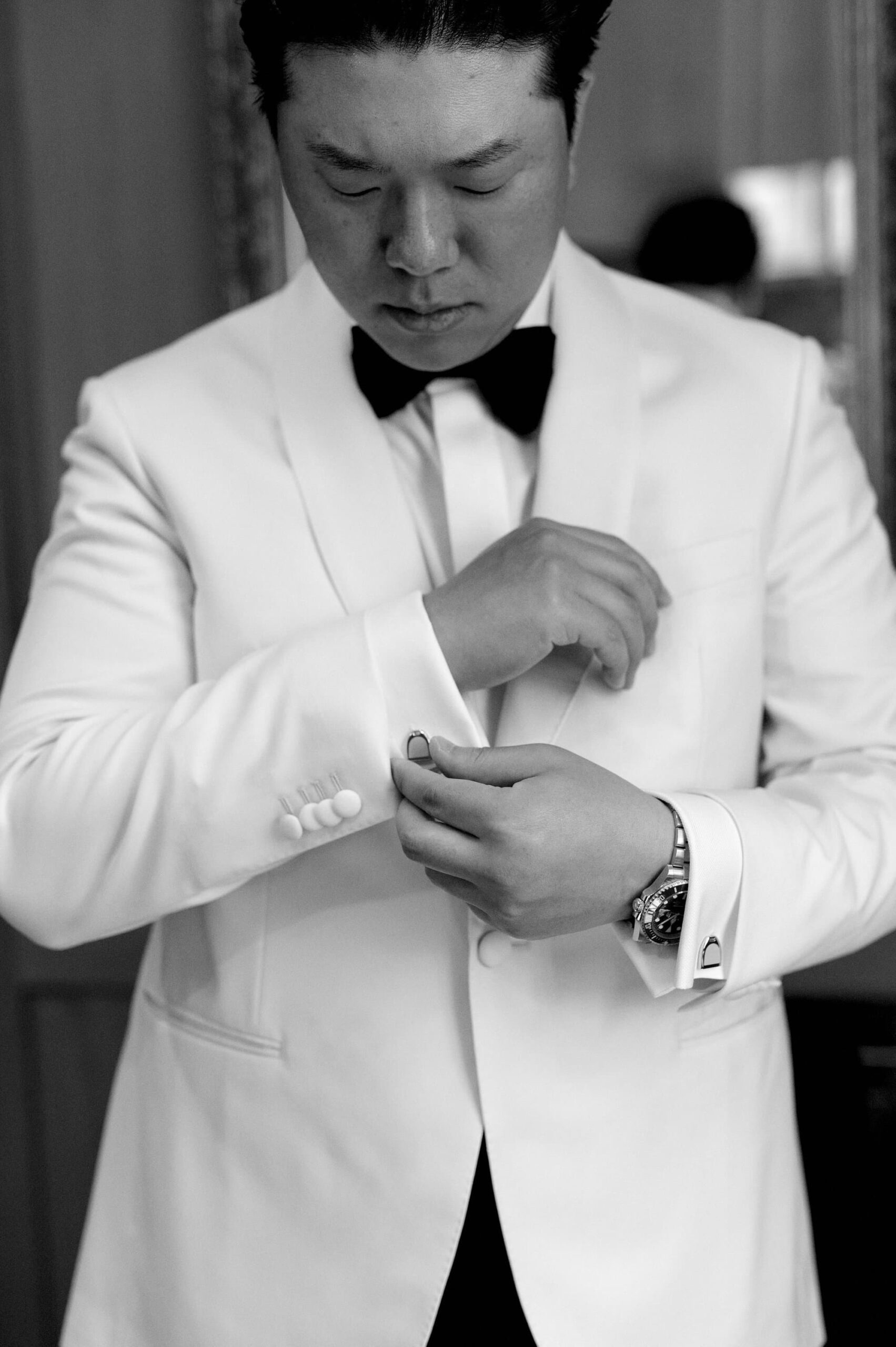 Groom posing in the library at Harding Waterfront Estate before the wedding ceremony