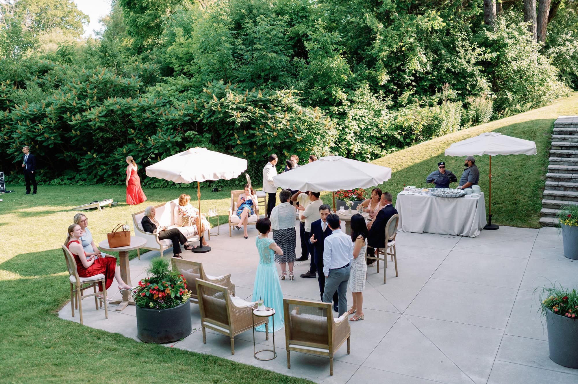 Guests enjoying outdoor cocktail hour on the lawn at Harding Waterfront Estate.