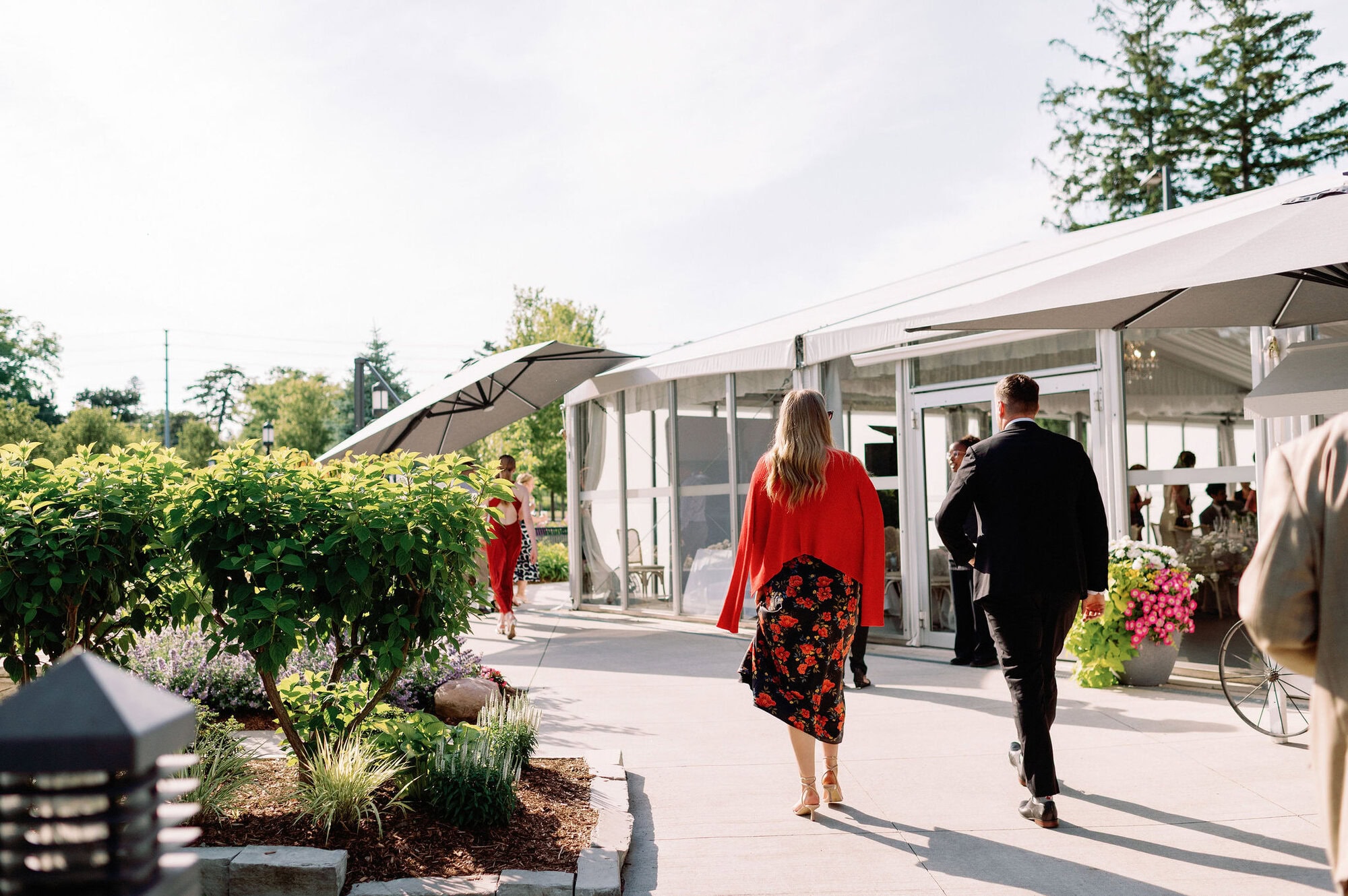 Guests arriving and walking toward the tented reception at Harding Waterfront Estate in Mississauga.