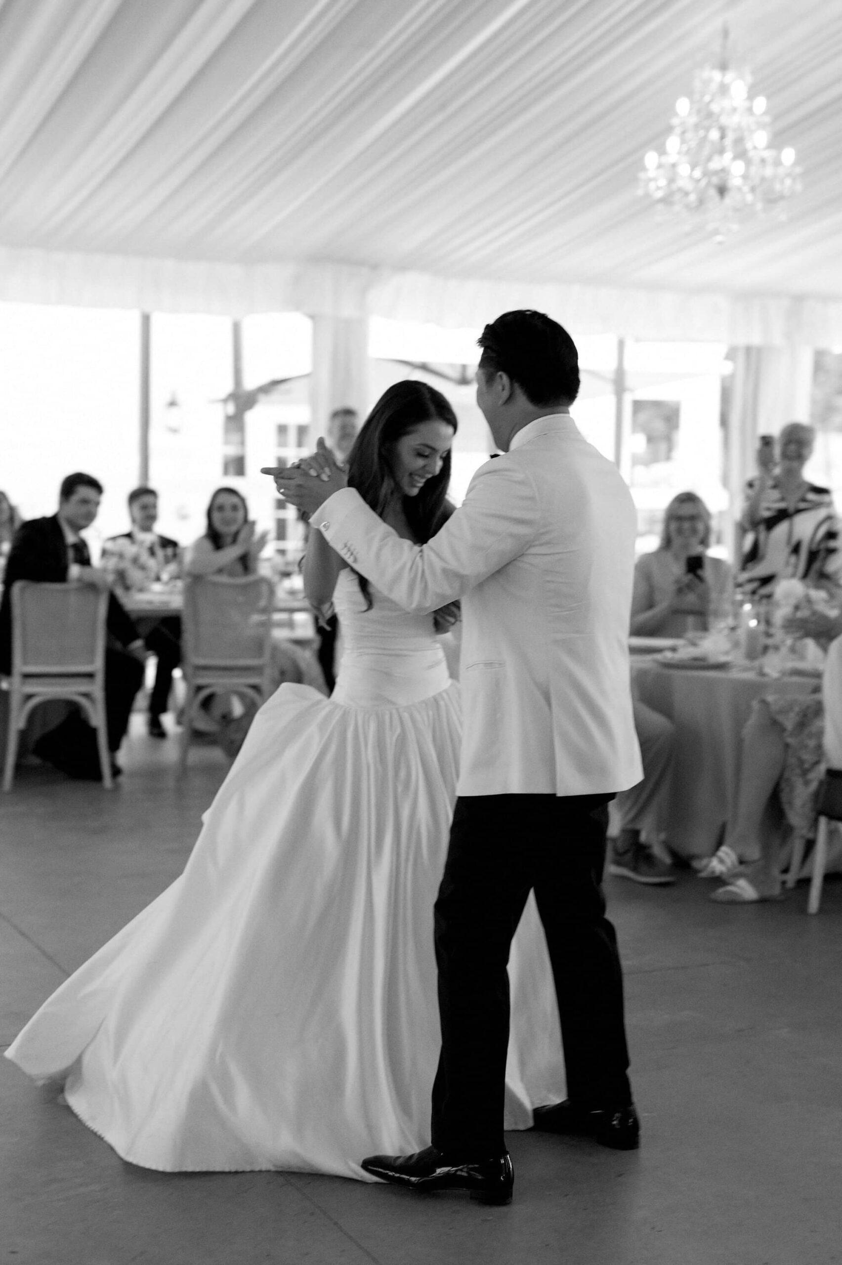 Black and white photo of the bride and groom dancing closely during their first dance at Harding Waterfront Estate.