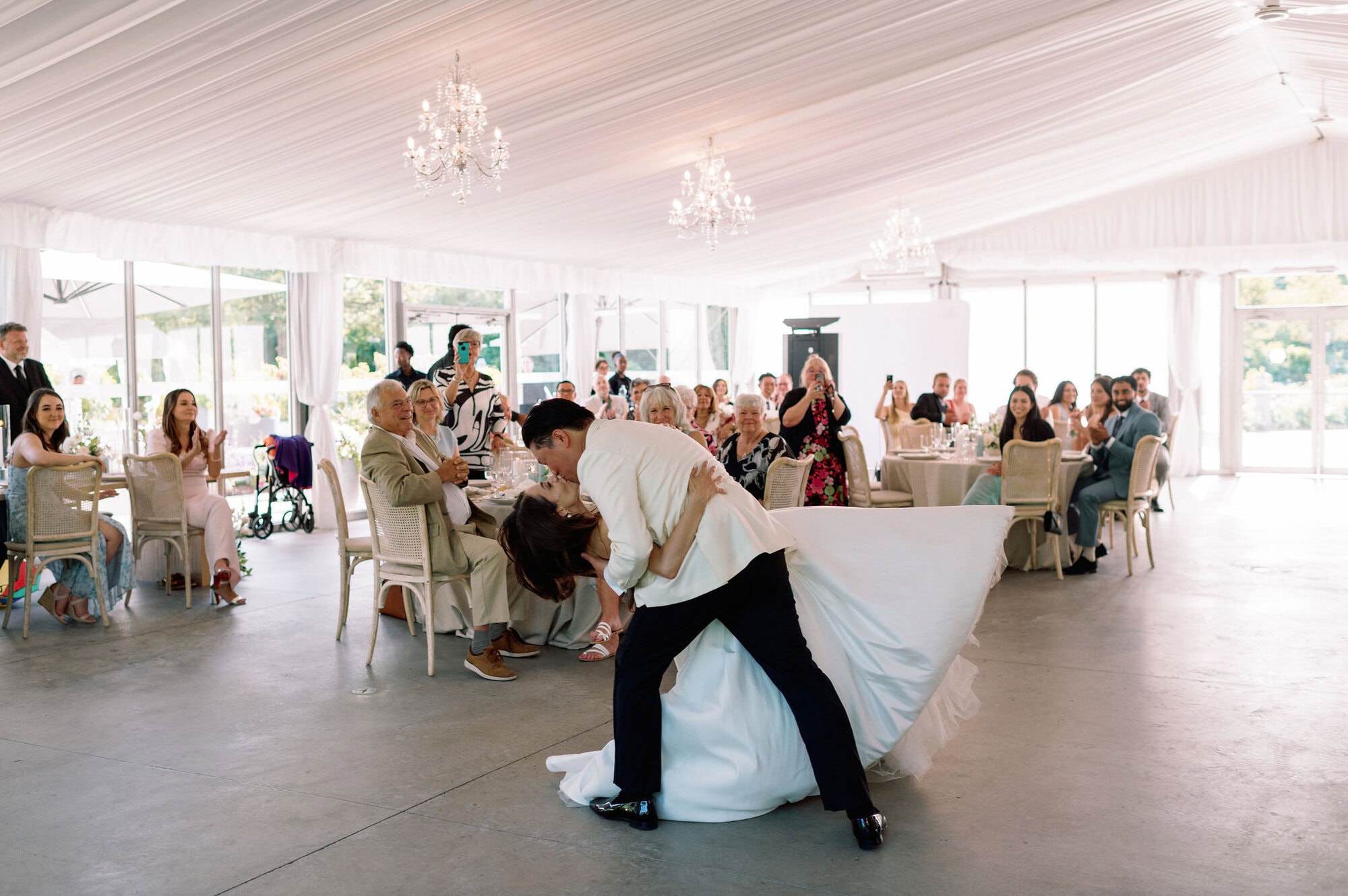 Bride and groom sharing a dramatic dip during their first dance at Harding Waterfront Estate.
