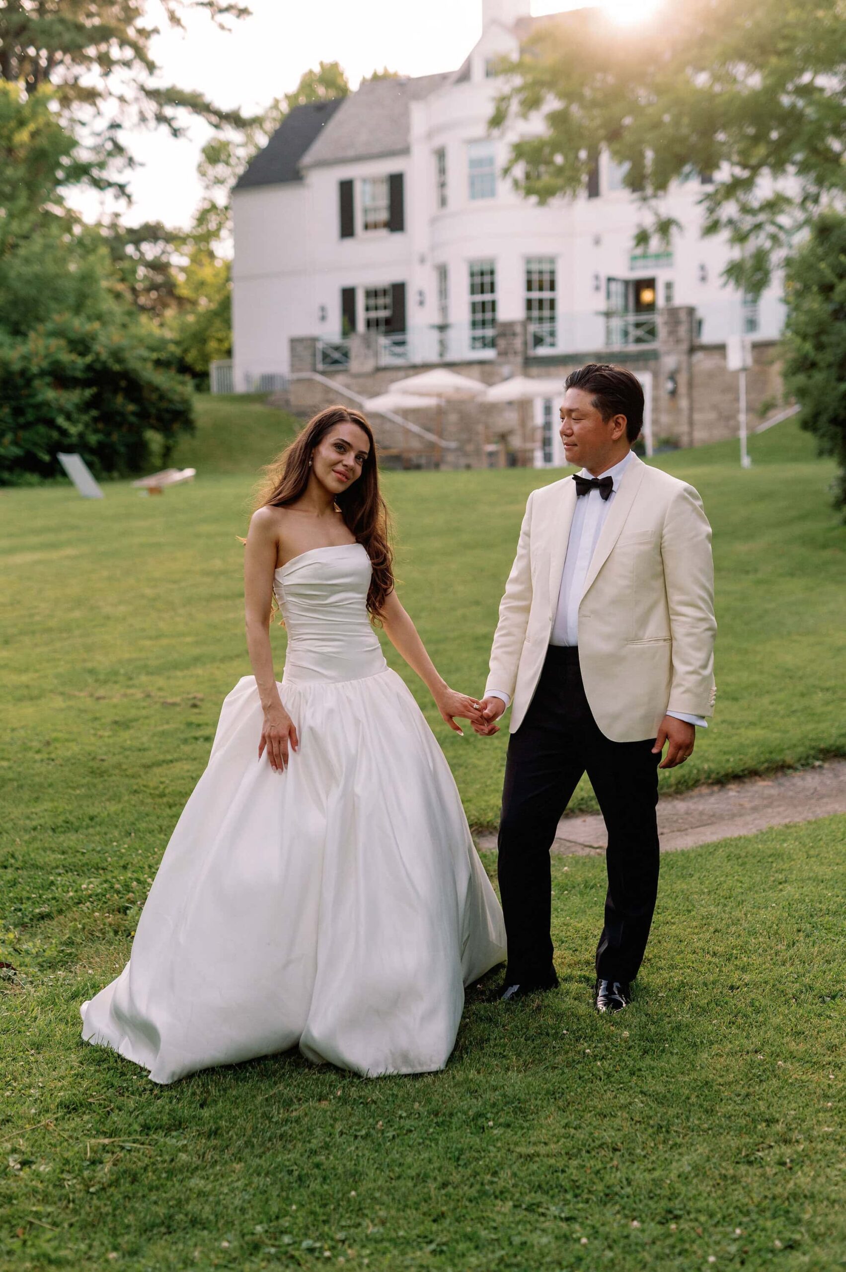 Bride and groom holding hands during their garden portraits at Harding Waterfront Estate.